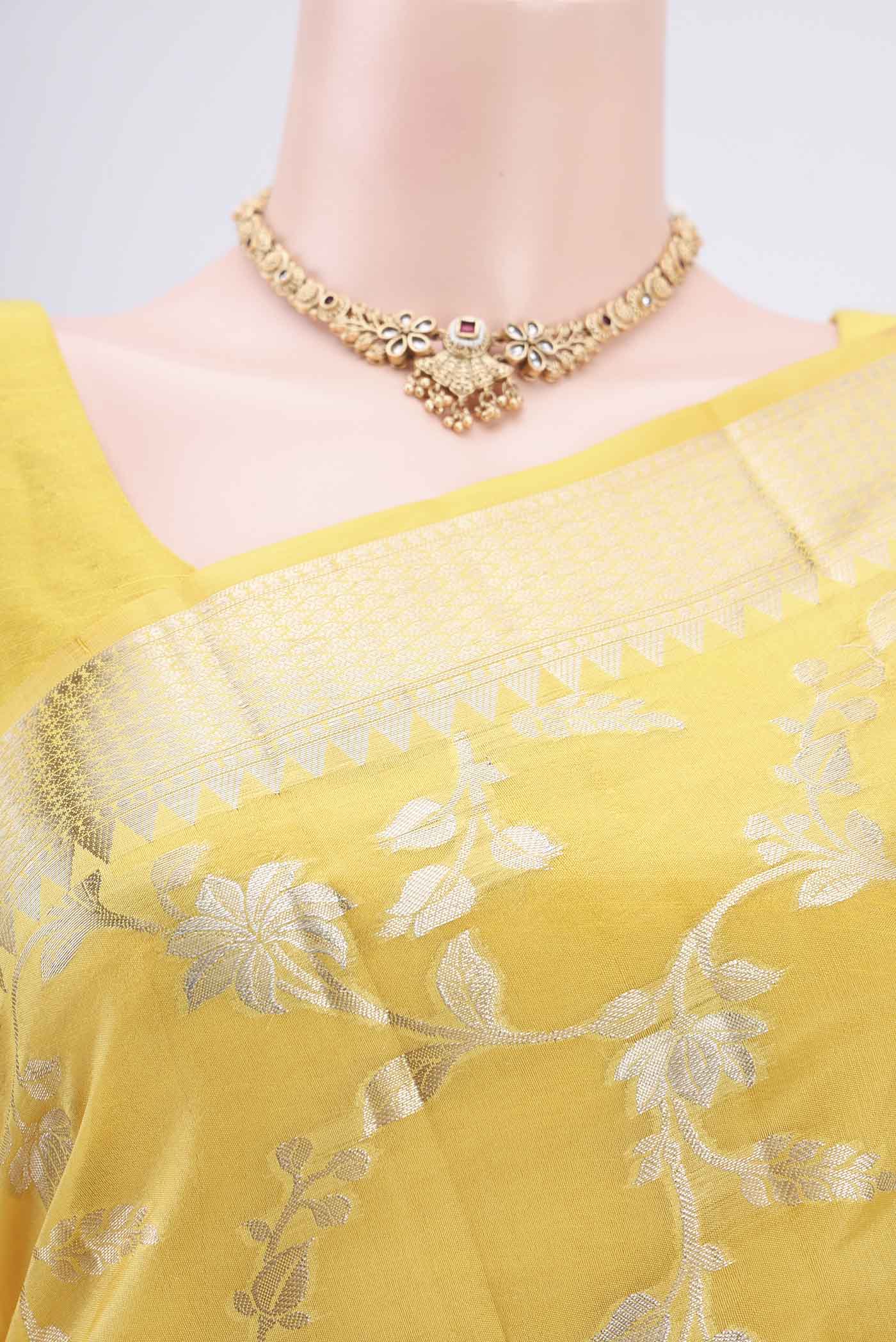 Border image of Yellow Banarasi Raw Silk Saree with Zari Butta on the body and Zari Border. 