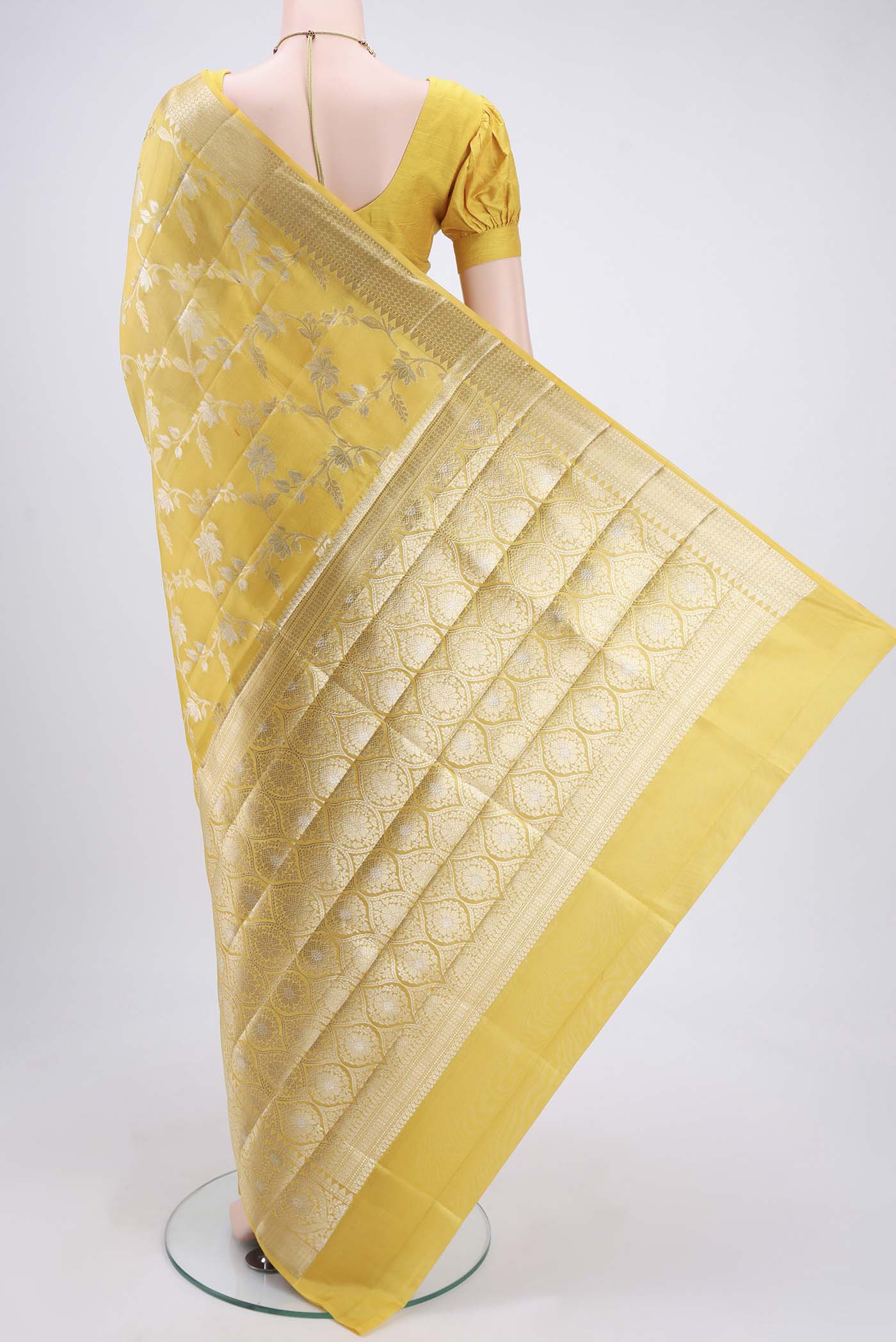 Flat view of Yellow Banarasi Raw Silk Saree with Zari Butta on the body and Zari Border. 