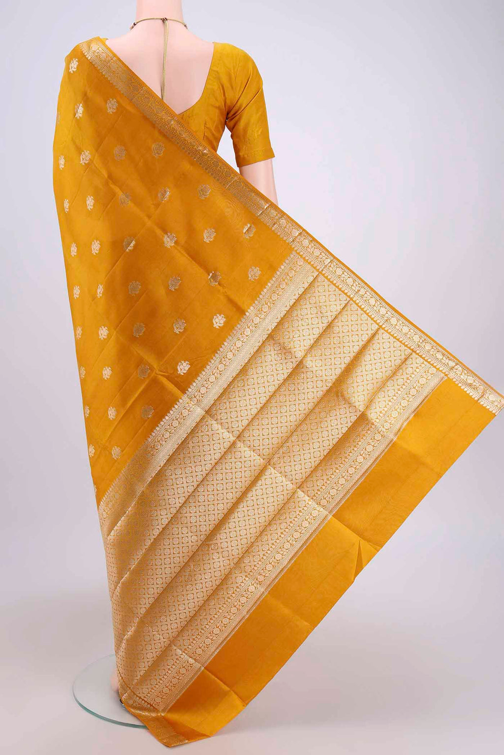Flat view of Mustard Banarasi Raw Silk Saree with Zari Butta on the body and Zari Border. 
