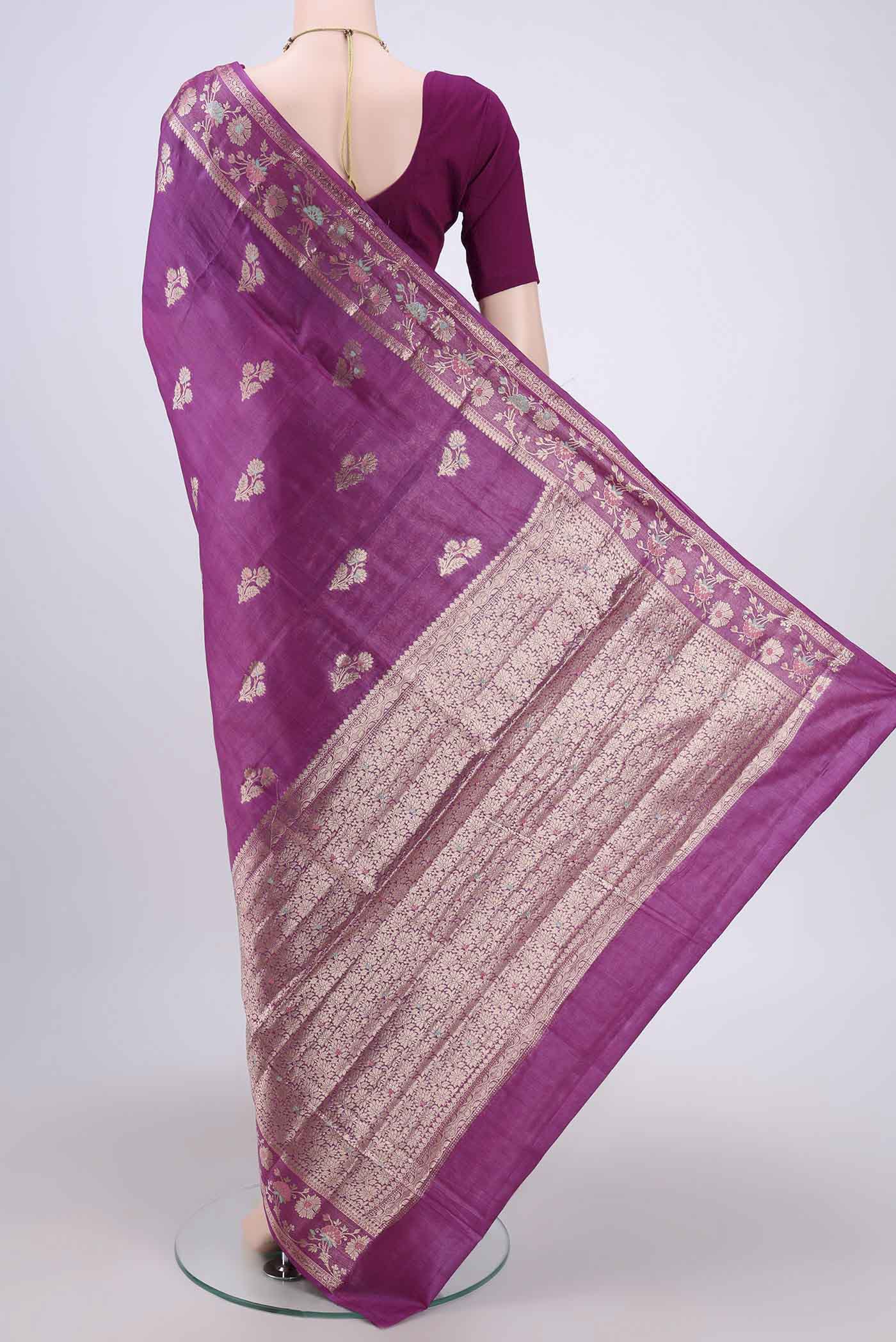 Flat view of Purple Banarasi Tussar Silk Saree with Zari Butta on the body and Zari And Thread Border. 