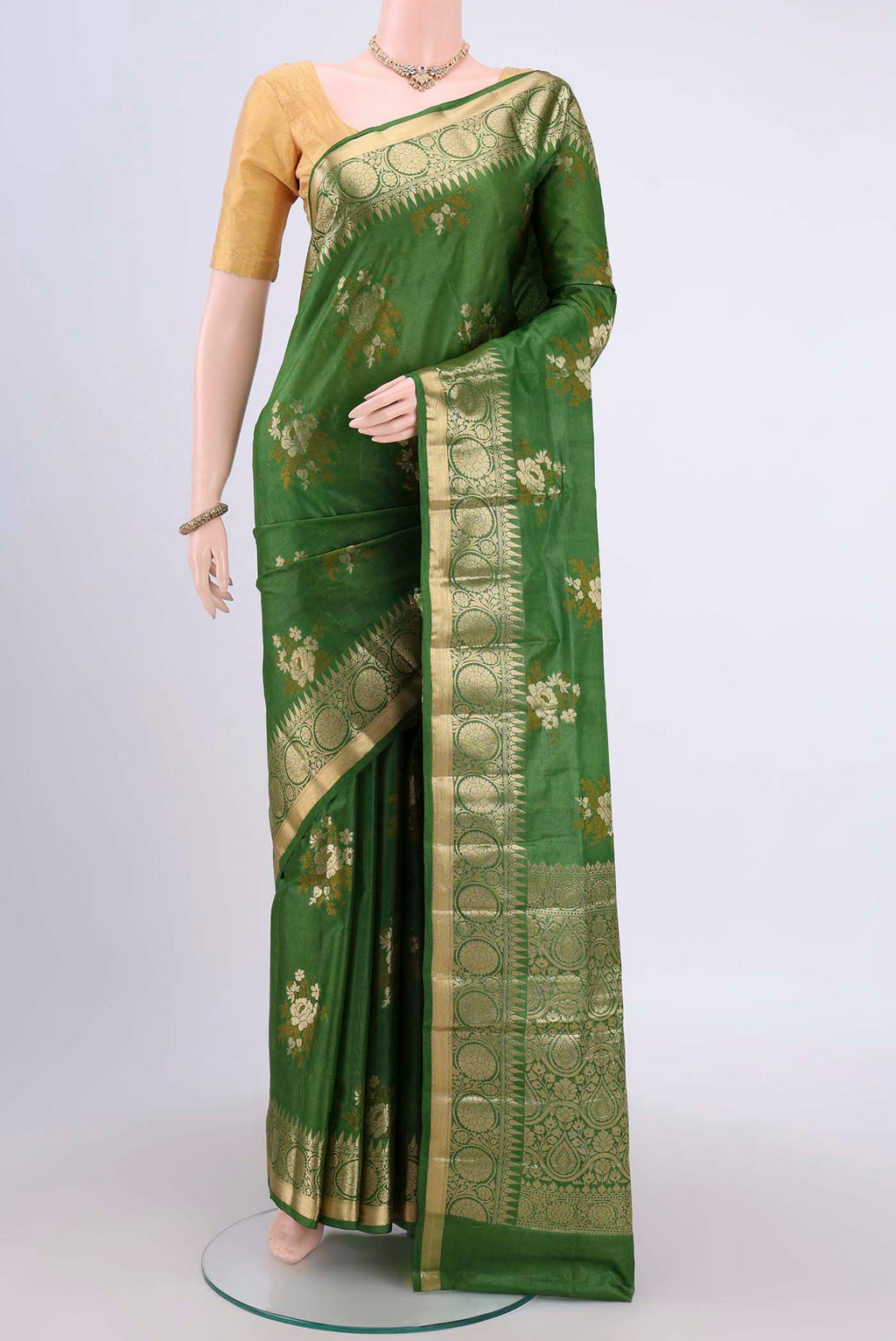 Green Banarasi Tussar Silk Saree with Zari Butta on the body and Zari Border.  displayed on a mannequin