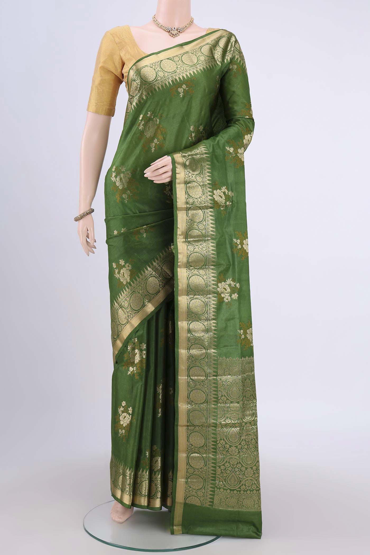 Green Banarasi Tussar Silk Saree with Zari Butta on the body and Zari Border.  displayed on a mannequin
