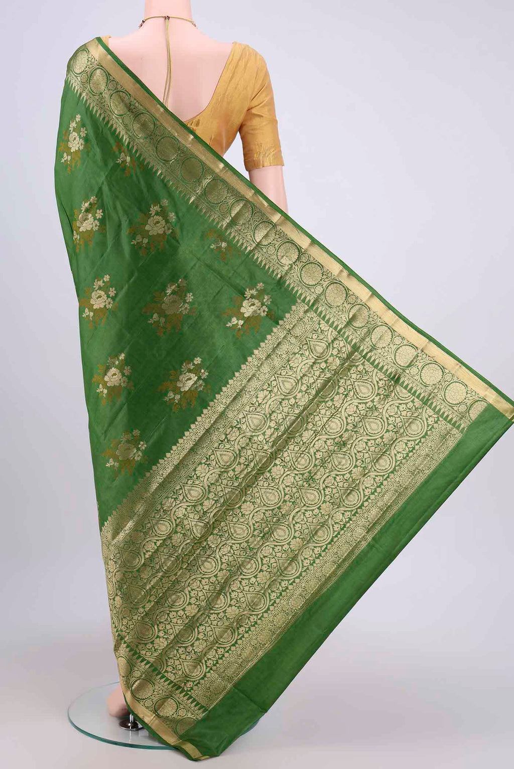Flat view of Green Banarasi Tussar Silk Saree with Zari Butta on the body and Zari Border. 