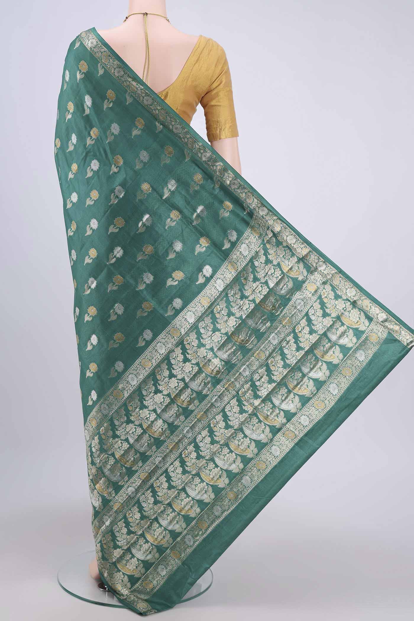 Flat view of Sea Green Banarasi Tussar Silk Saree with Zari Butta on the body and Zari Border. 