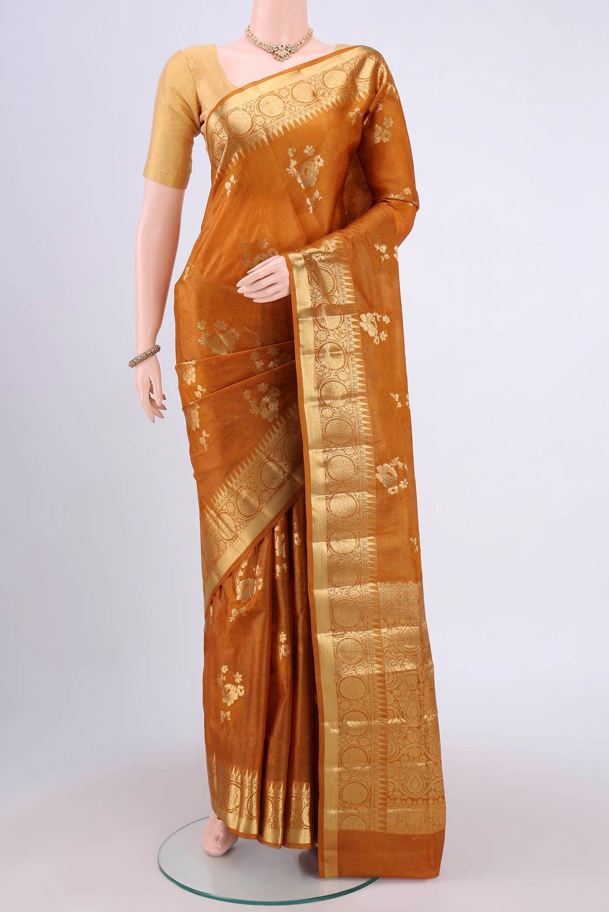 Mustard Banarasi Tussar Silk Saree with Zari Butta on the body and Zari Border.  displayed on a mannequin