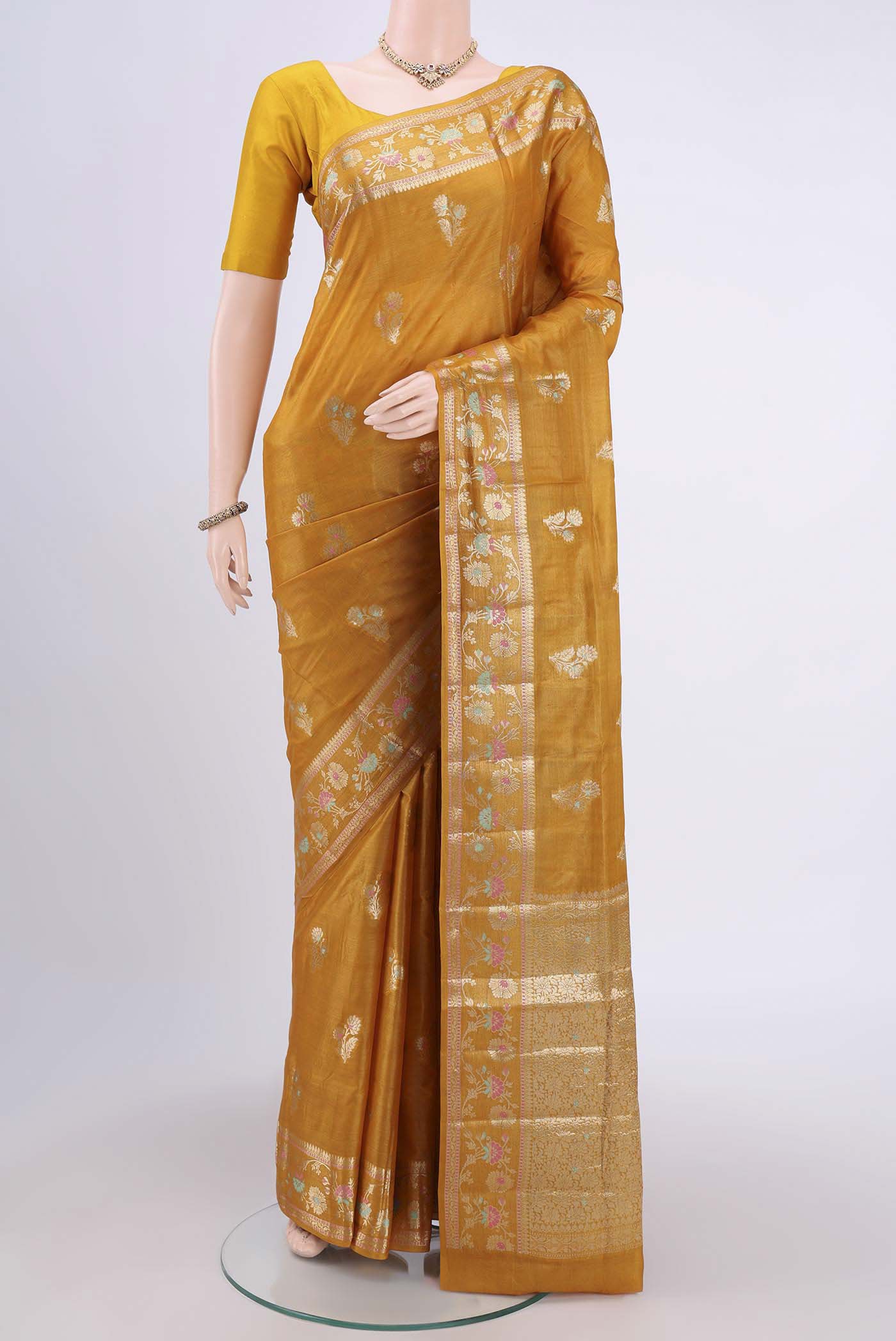 Mustard Banarasi Tussar Silk Saree with Zari Butta on the body and Zari Border.  displayed on a mannequin