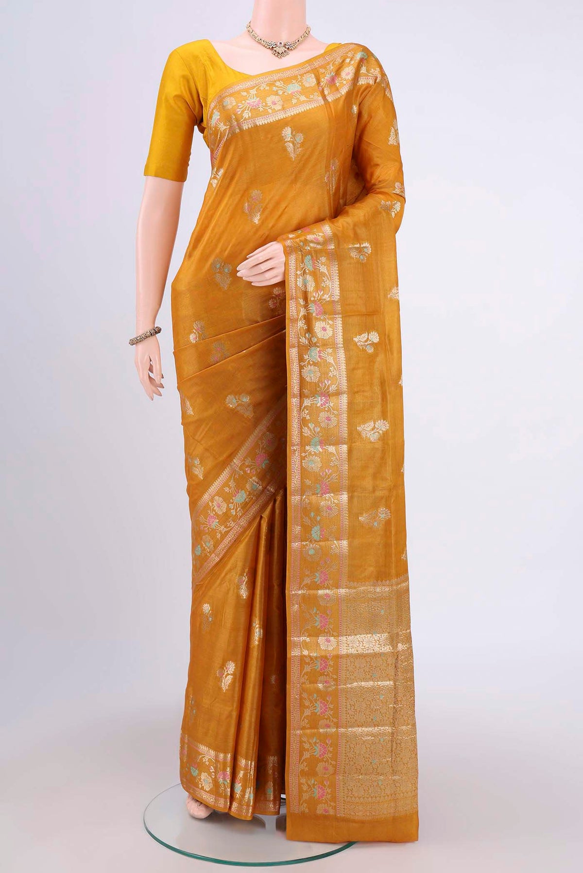 Mustard Banarasi Tussar Silk Saree with Zari Butta on the body and Zari Border.  displayed on a mannequin