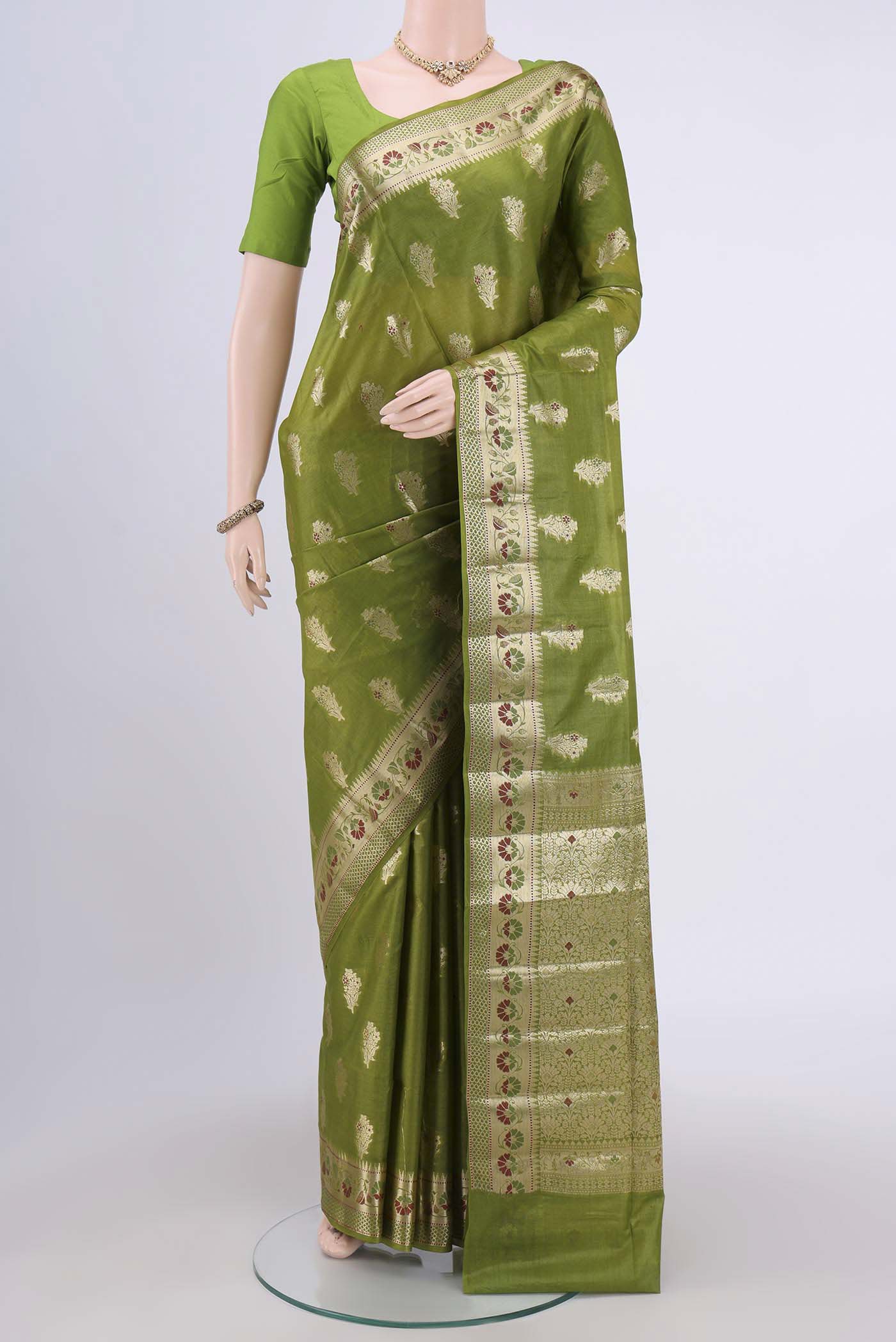 Green Banarasi Tussar Silk Saree with Zari Butta on the body and Zari Border.  displayed on a mannequin