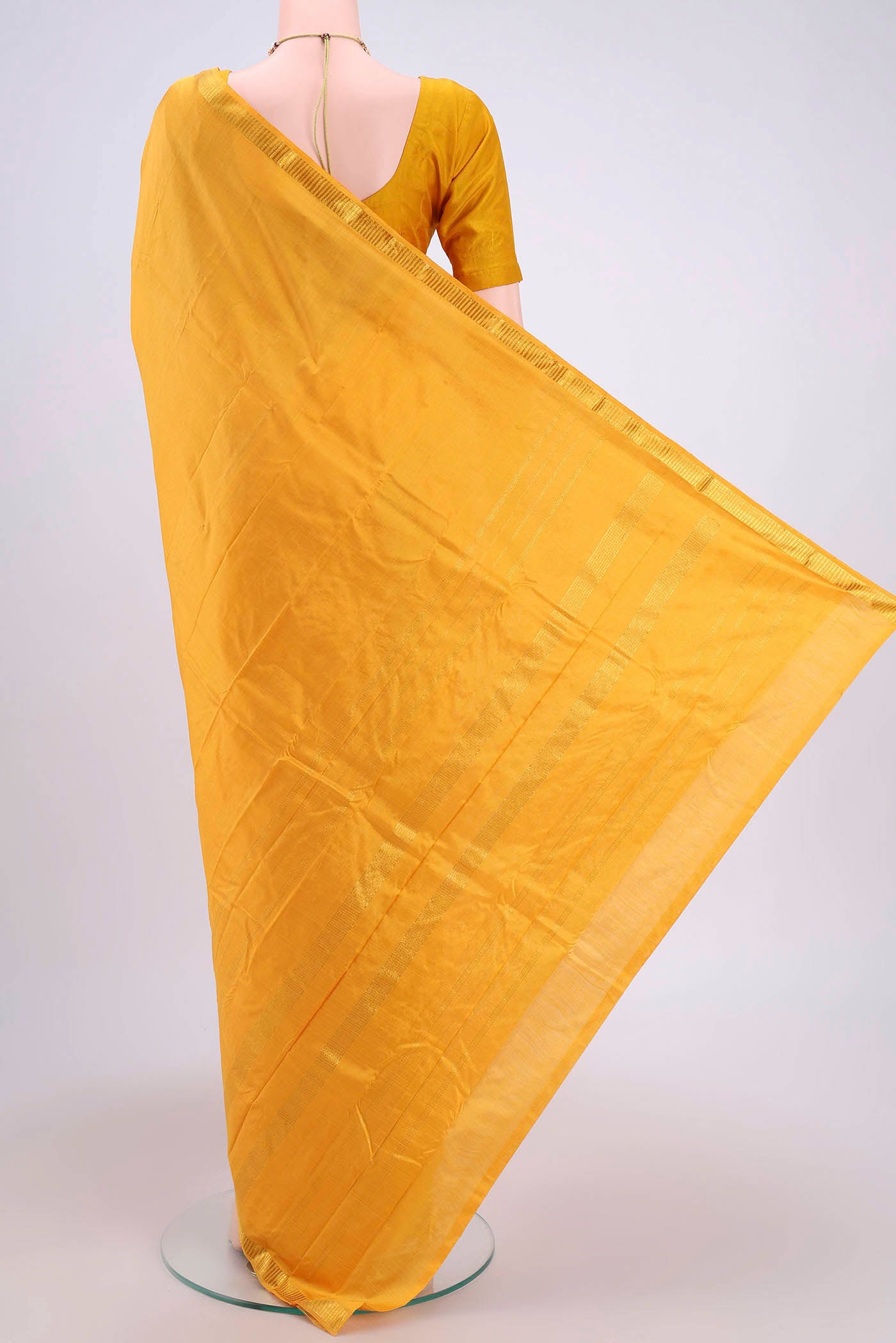 Flat view of Yellow Kanchipuram Saree with Plain Body and Zari Border. 