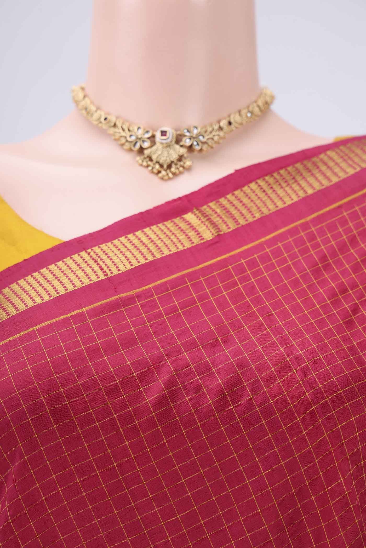 Border image of Maroon Dual Tone Kanchipuram Silk Saree with Checked design on the body and Zari Border. 