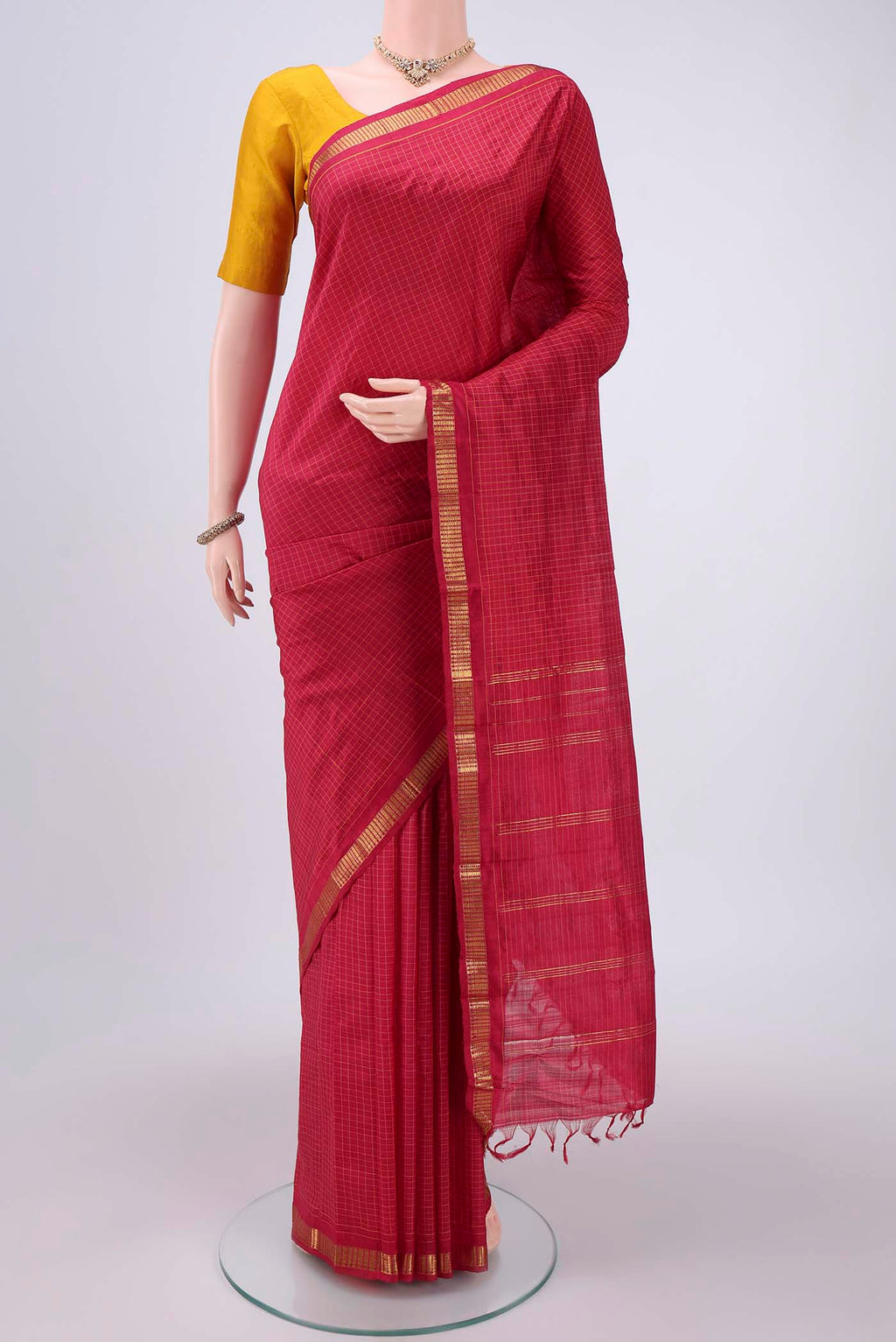 Maroon Dual Tone Kanchipuram Silk Saree with Checked design on the body and Zari Border.  displayed on a mannequin