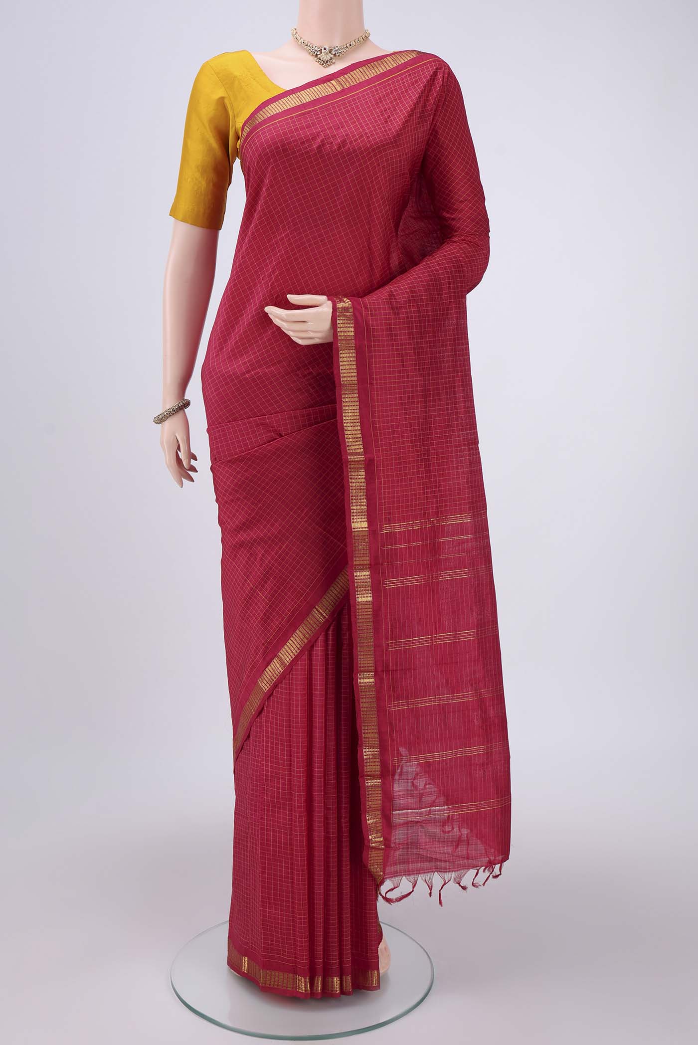 Maroon Dual Tone Kanchipuram Silk Saree with Checked design on the body and Zari Border.  displayed on a mannequin