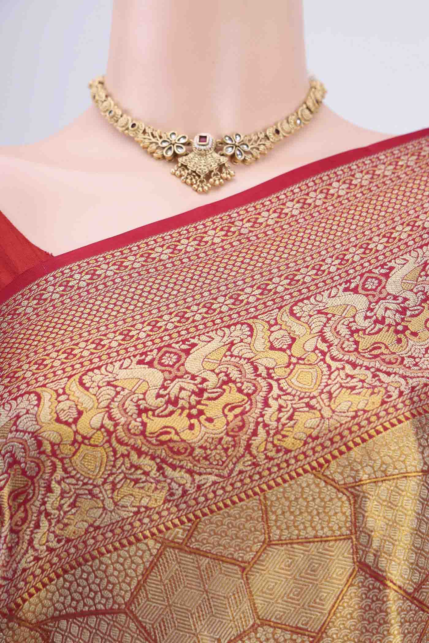 Border image of Maroon Kanchipuram Saree with Zari Brocade on the body and Zari Border. 