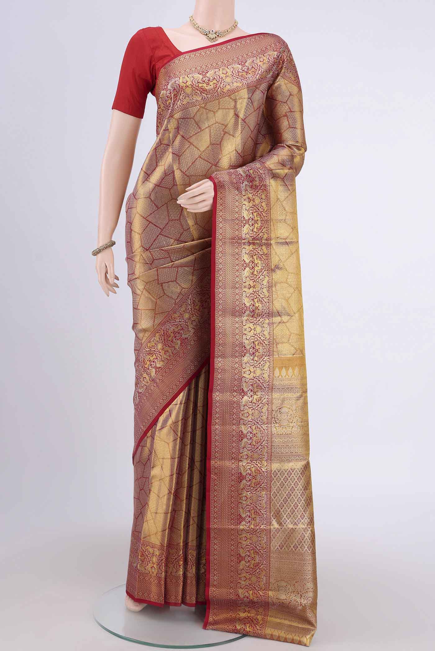 Maroon Kanchipuram Saree with Zari Brocade on the body and Zari Border.  displayed on a mannequin