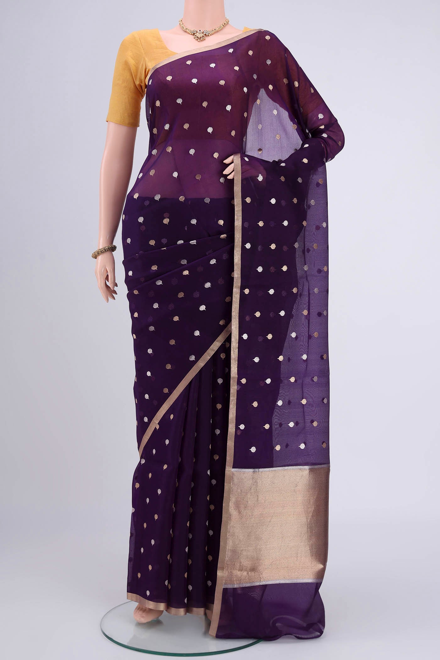 Purple Organza Silk Saree with Zari Butta on the body and Zari Border.  displayed on a mannequin