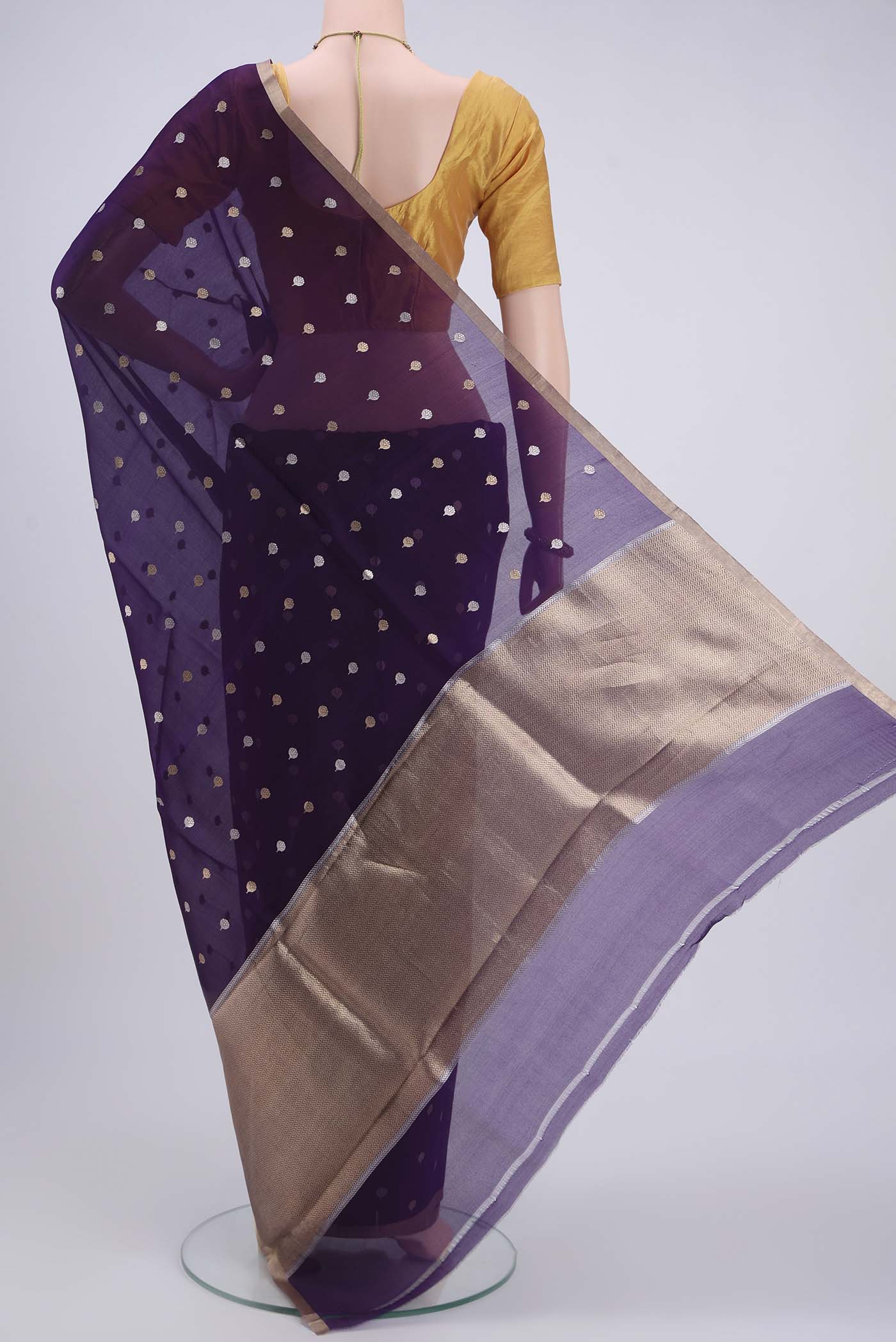 Flat view of Purple Organza Silk Saree with Zari Butta on the body and Zari Border. 