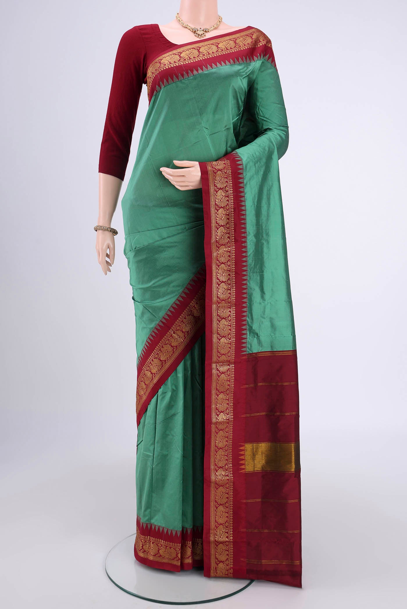 Sage Green Blended Bangalore Silk Saree with Zari Butta on the body and Zari Border.  displayed on a mannequin
