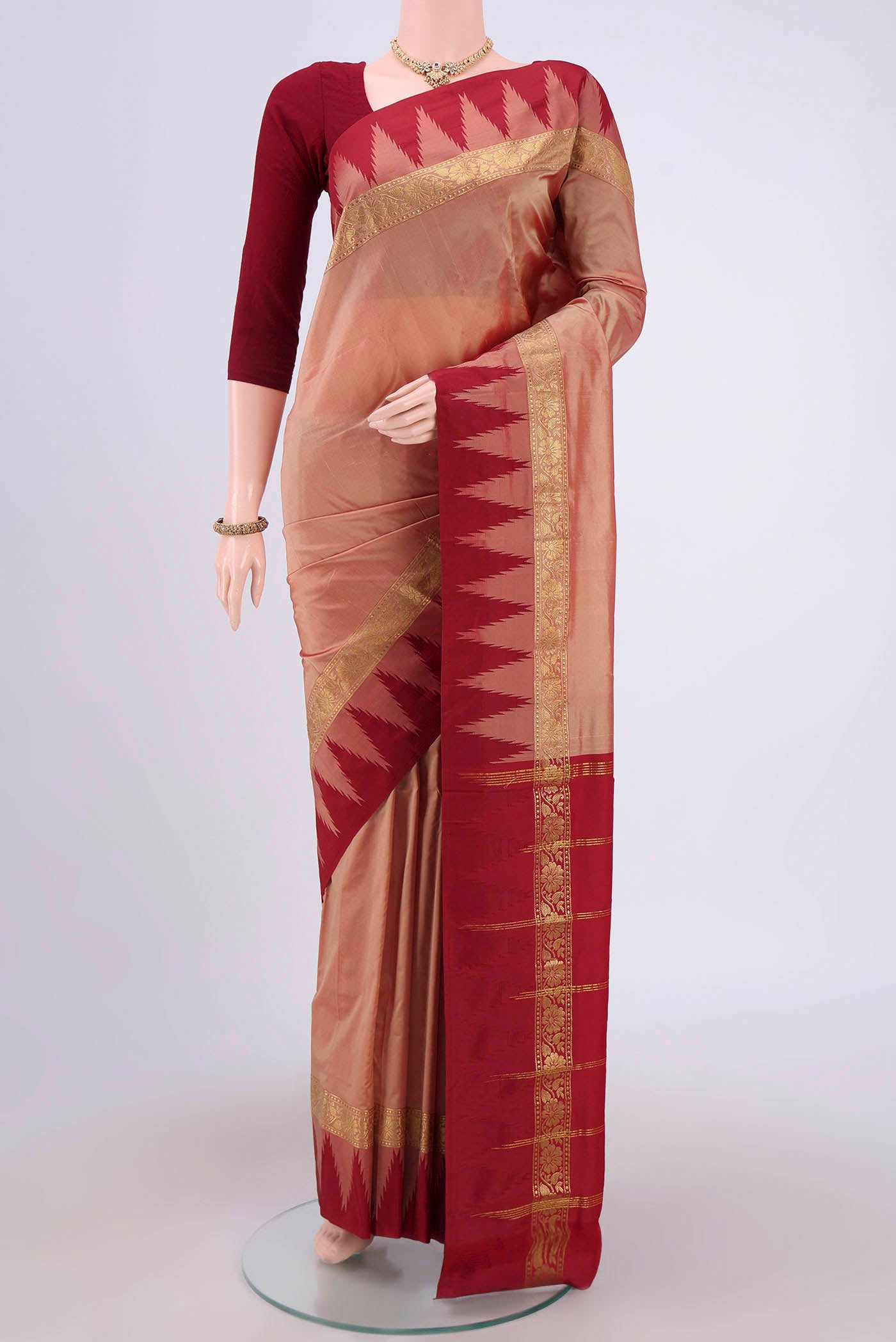 Coral Blended Bangalore Silk Saree with Zari Butta on the body and Temple Border.  displayed on a mannequin
