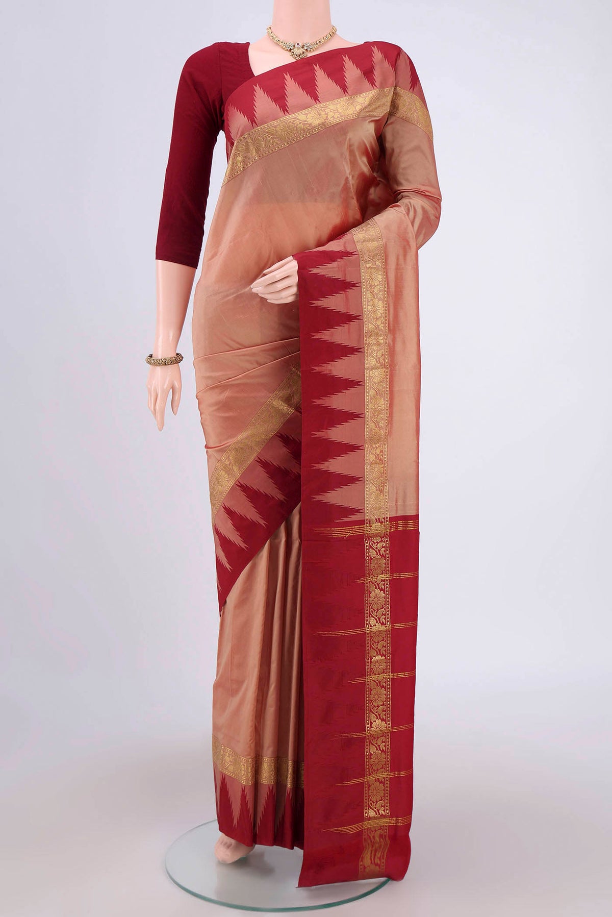 Coral Blended Bangalore Silk Saree with Zari Butta on the body and Temple Border.  displayed on a mannequin