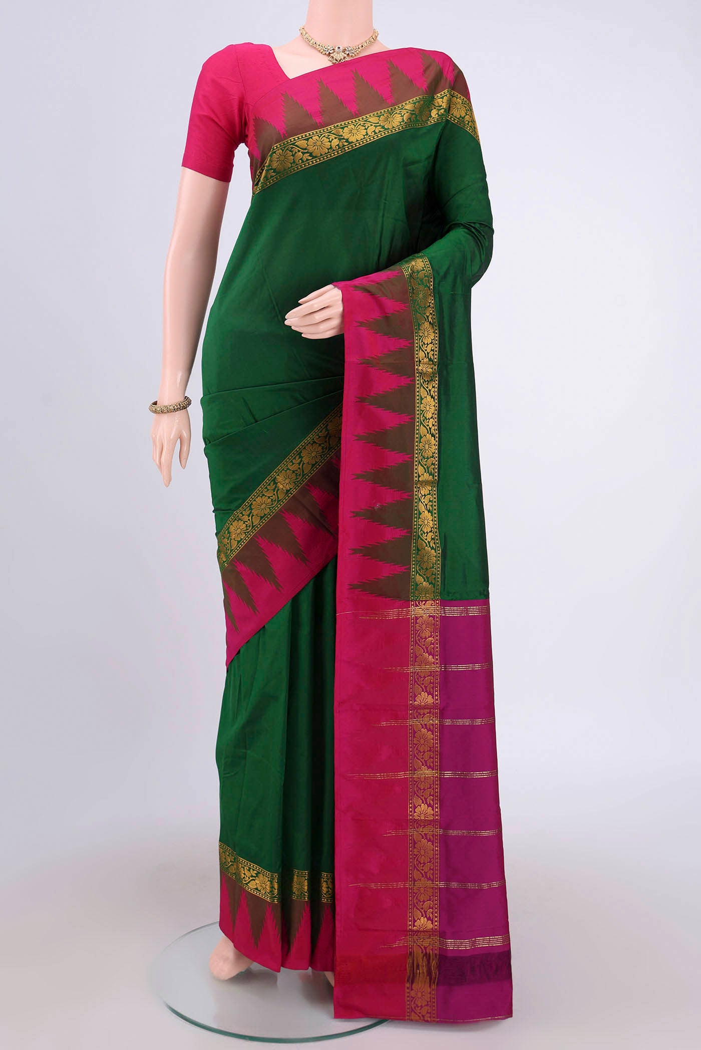 Bottle Green Blended Bangalore Silk Saree with Zari Butta on the body and Zari Border.  displayed on a mannequin
