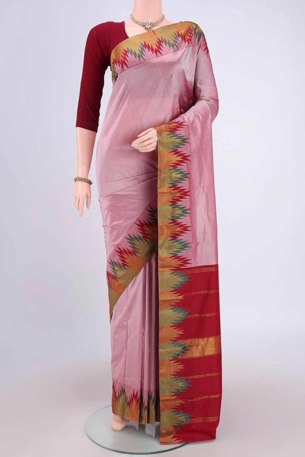 Coral Blended Bangalore Silk Saree with Zari Butta on the body and Temple Border.  displayed on a mannequin