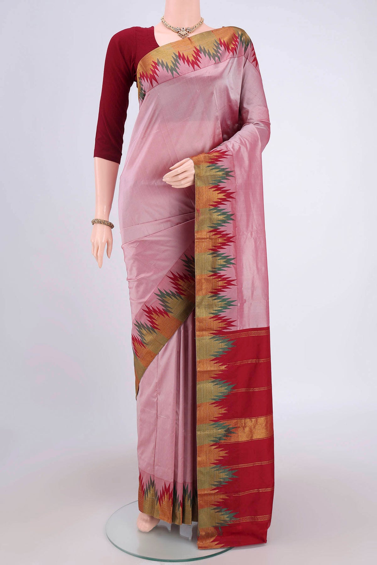 Coral Blended Bangalore Silk Saree with Zari Butta on the body and Temple Border.  displayed on a mannequin