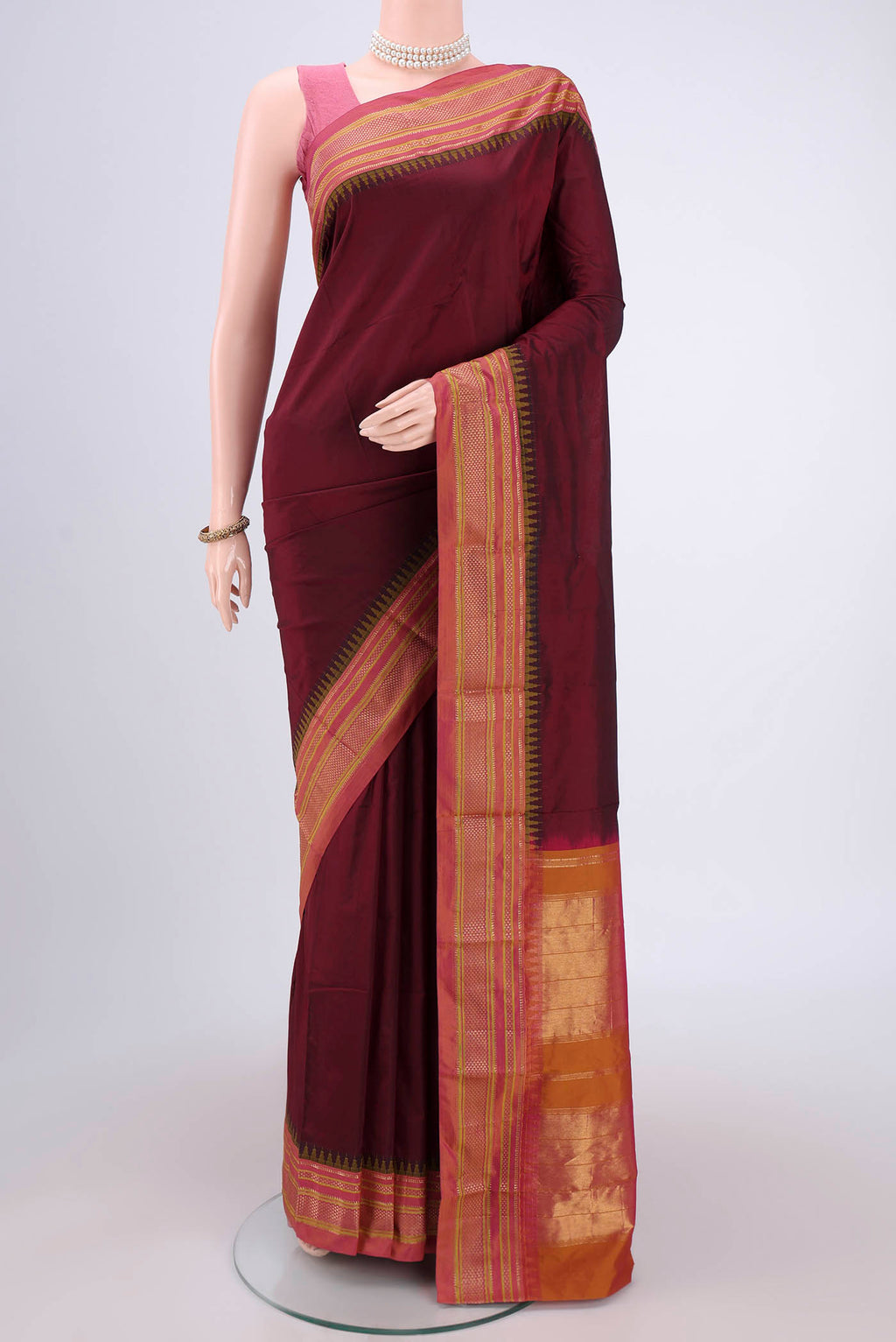 Maroon Blended Bangalore Silk Saree with Plain Body and Temple Border.  displayed on a mannequin