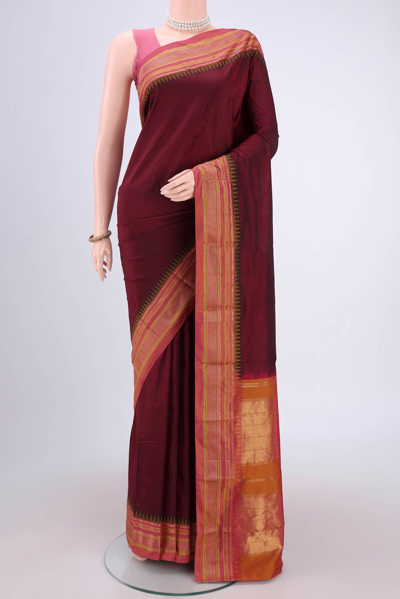 Maroon Blended Bangalore Silk Saree with Plain Body and Temple Border.  displayed on a mannequin