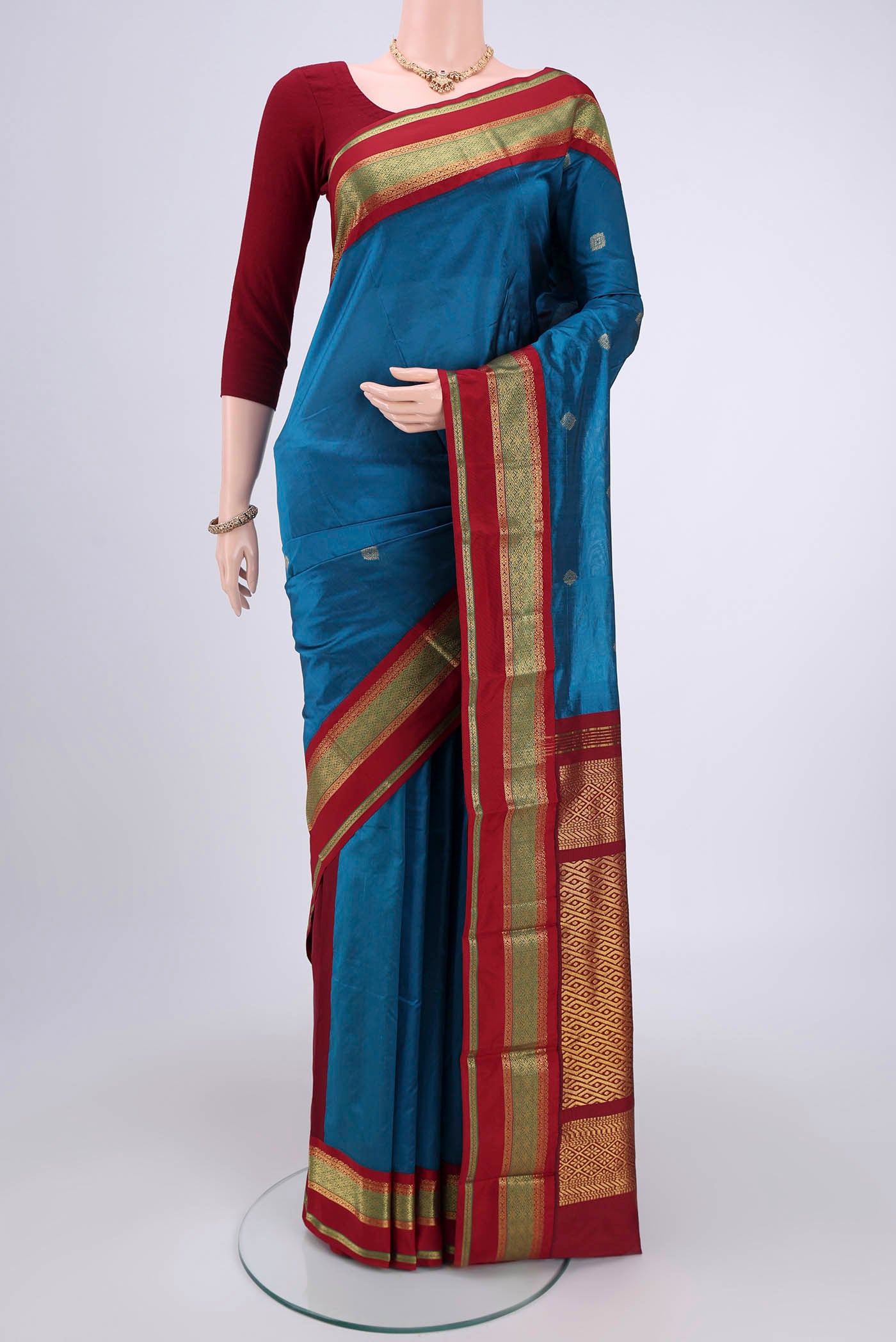 Blue Blended Bangalore Silk Saree with Zari Butta on the body and Zari Border.  displayed on a mannequin