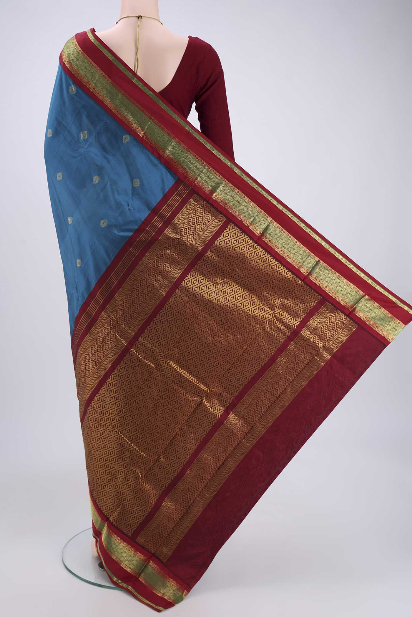 Flat view of Blue Blended Bangalore Silk Saree with Zari Butta on the body and Zari Border. 