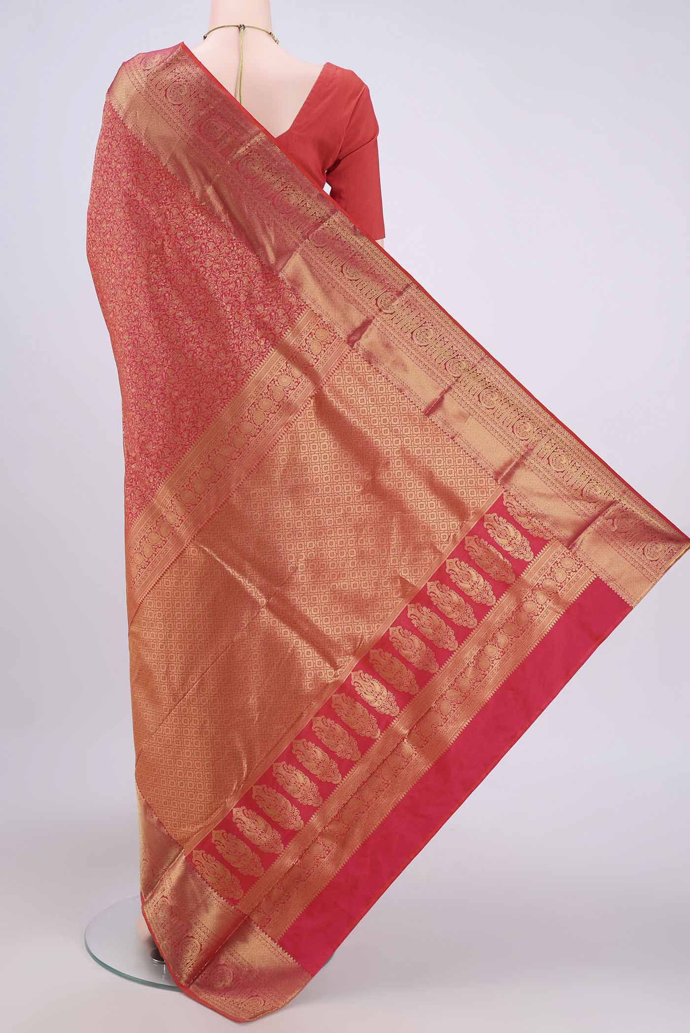 Flat view of Rust Bangalore Silk Saree with Zari Brocade on the body and Zari Border. 