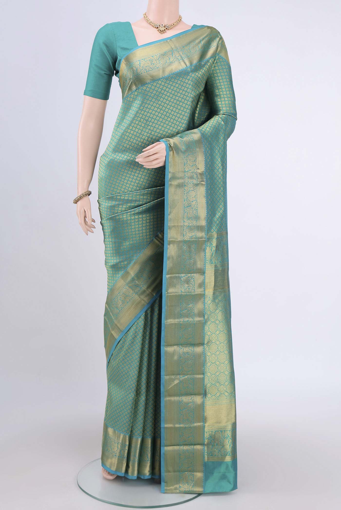 Sea Green Dual Tone Bangalore Silk Saree with Zari Brocade on the body and Zari Border.  displayed on a mannequin