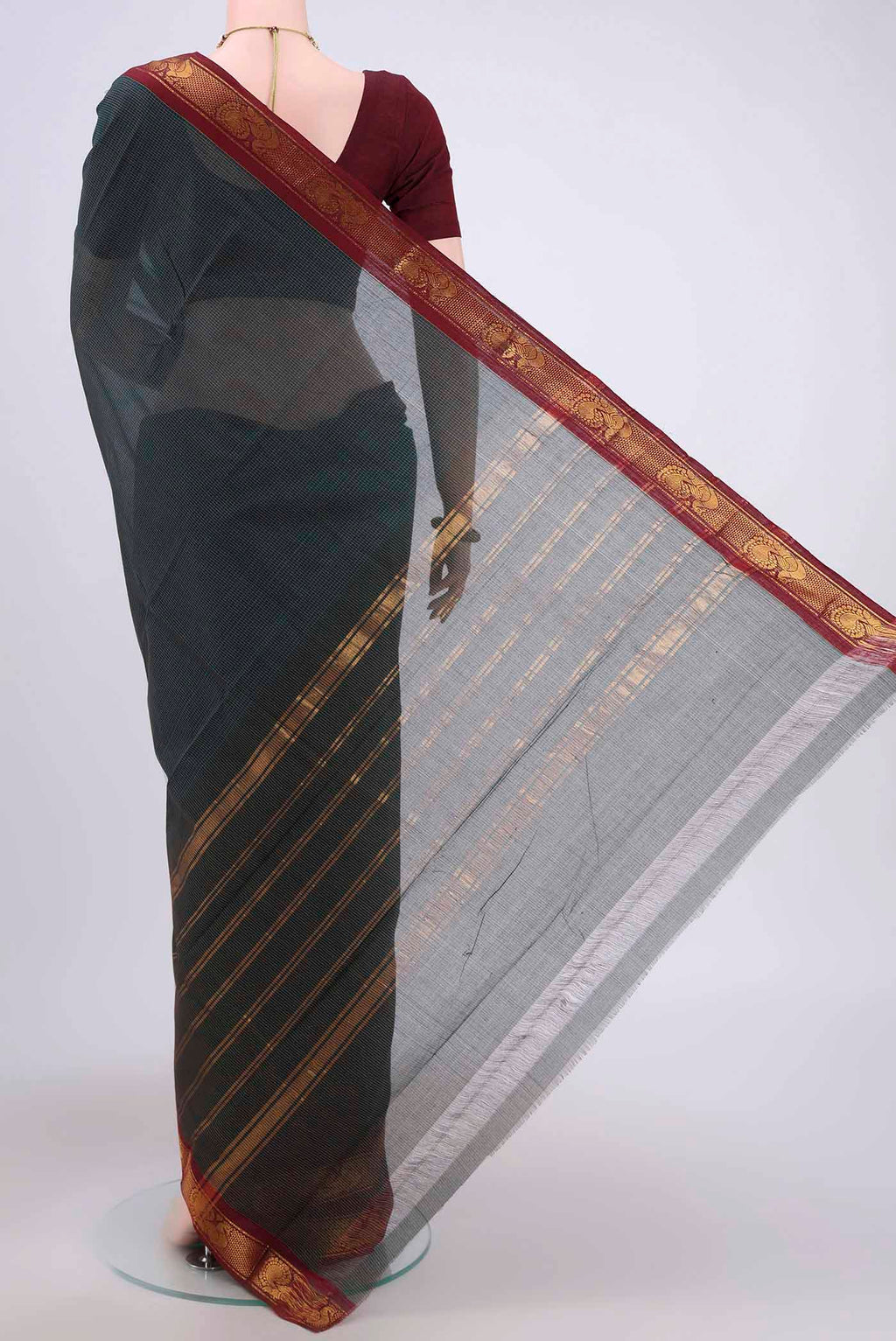 Flat view of Bottle Green Kanchi Cotton Saree with Stripes on the body and Zari Border. 