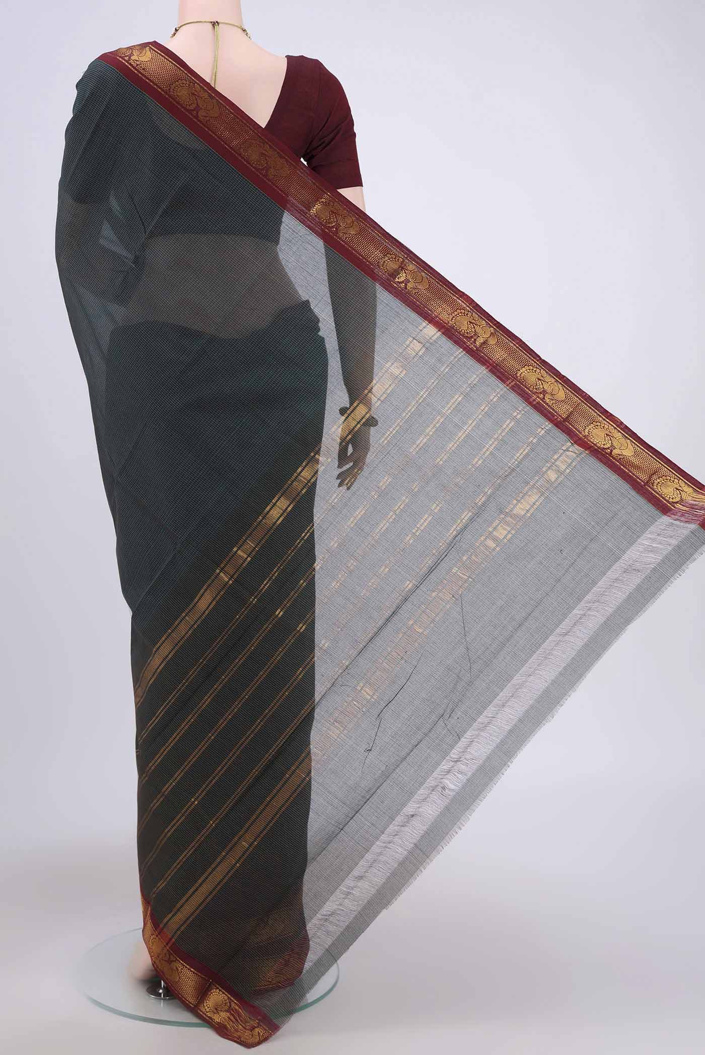 Flat view of Bottle Green Kanchi Cotton Saree with Stripes on the body and Zari Border. 