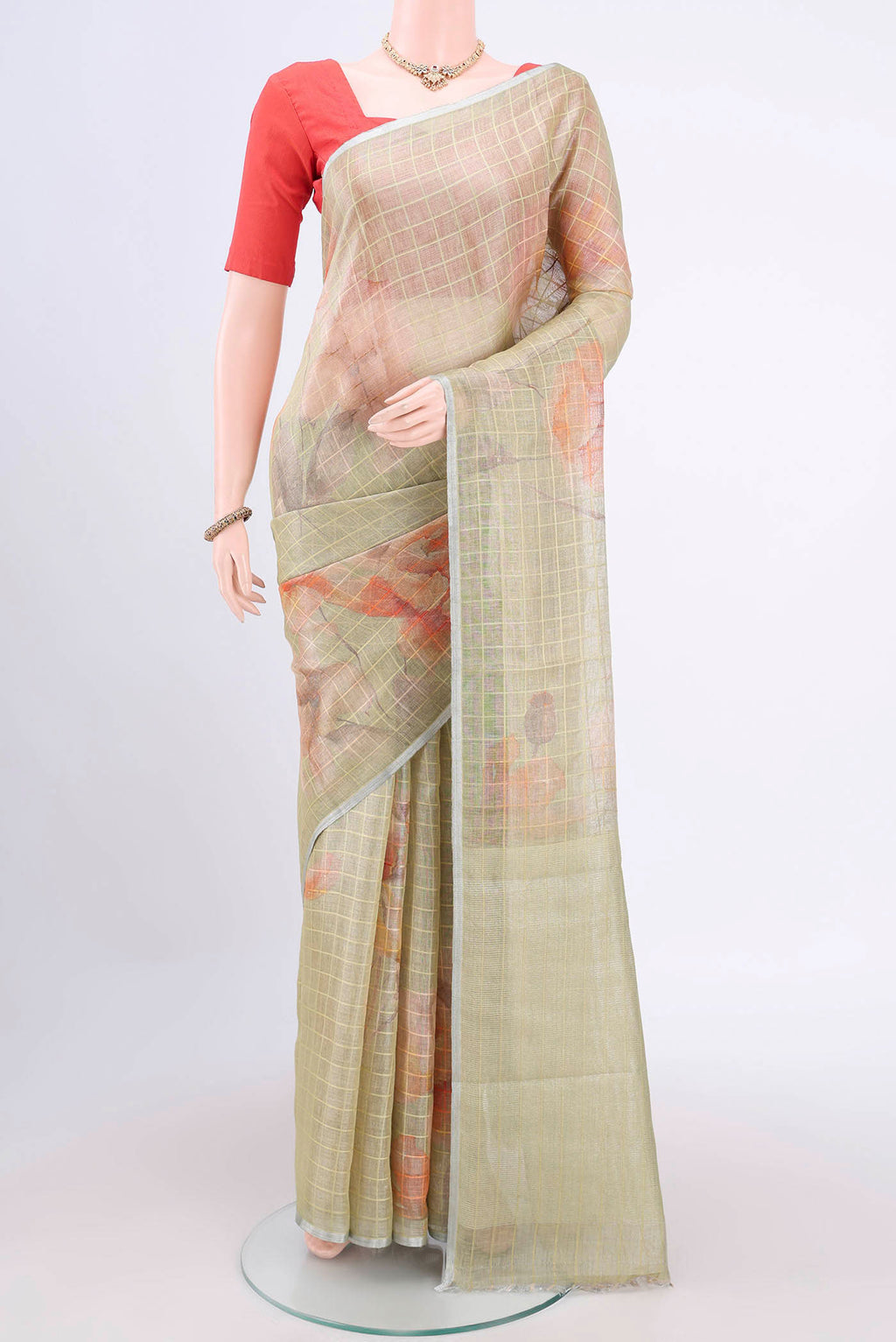 Mehandi Green Linen Cotton Saree with Floral Print on the body and Zari Border.  displayed on a mannequin