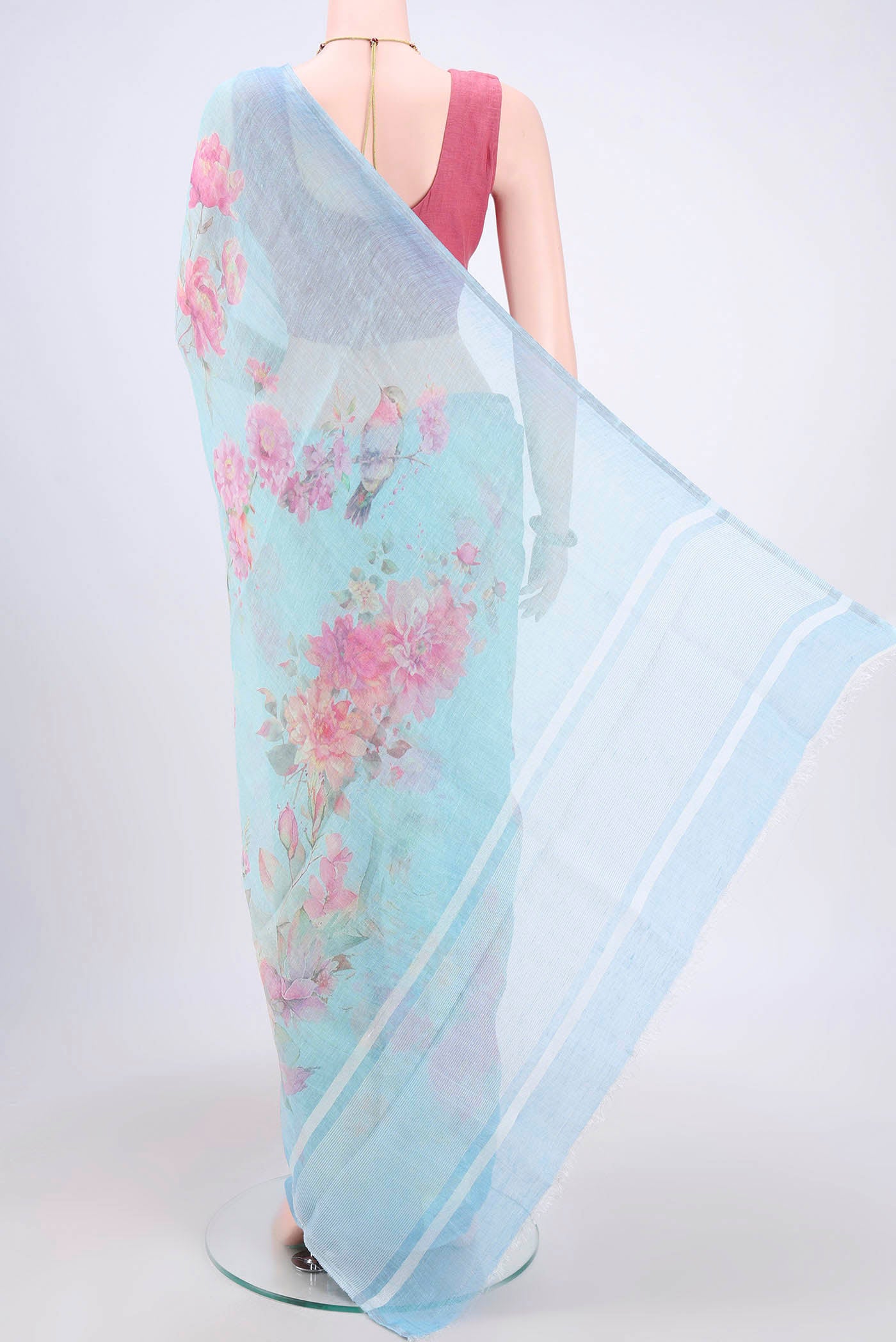 Flat view of Mint Green Linen Cotton Saree with Floral Print on the body and Zari Border. 