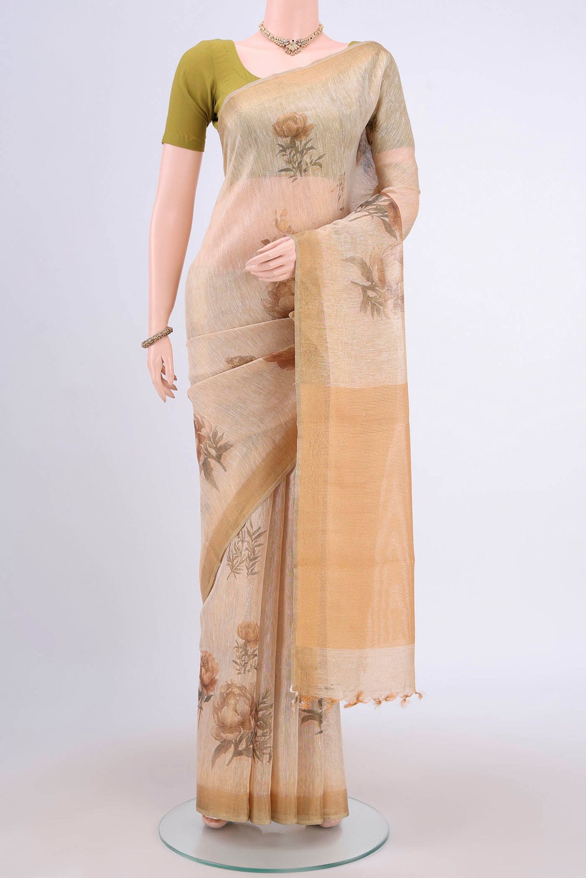 Mustard Linen Cotton Saree with Floral Print on the body and Zari Border.  displayed on a mannequin