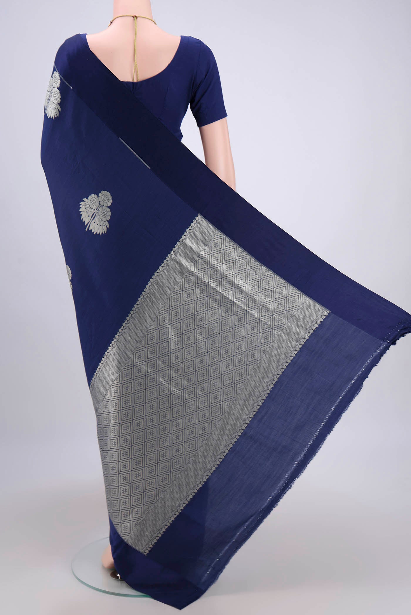 Flat view of Navy Blue Soft Silk Saree with Zari Butta on the body and Without Border. 