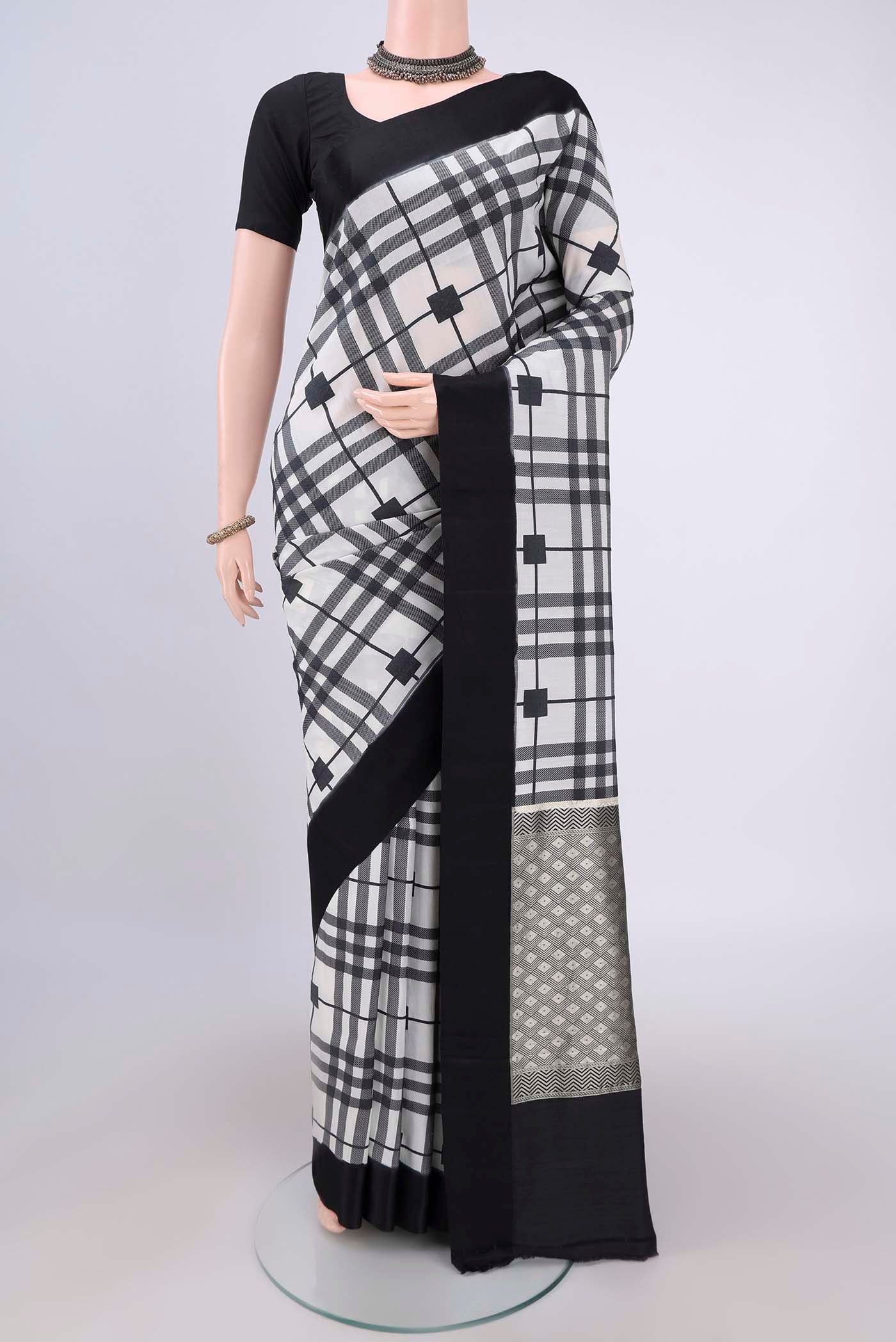 White Soft Silk Saree with Checked design on the body and Without Border.  displayed on a mannequin