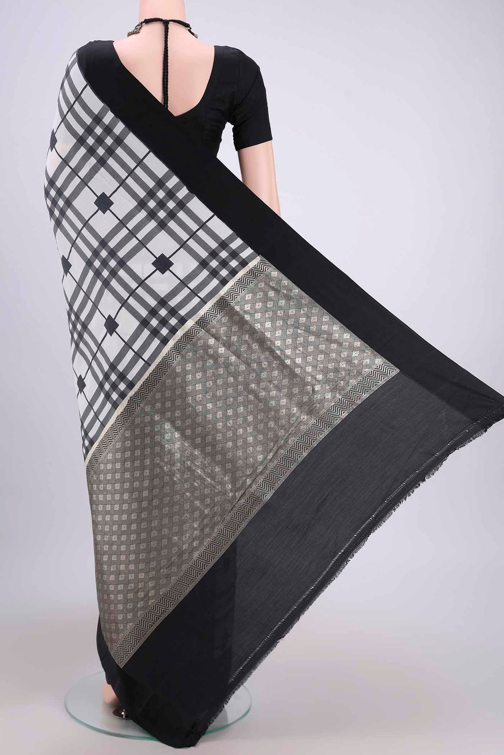 Flat view of White Soft Silk Saree with Checked design on the body and Without Border. 