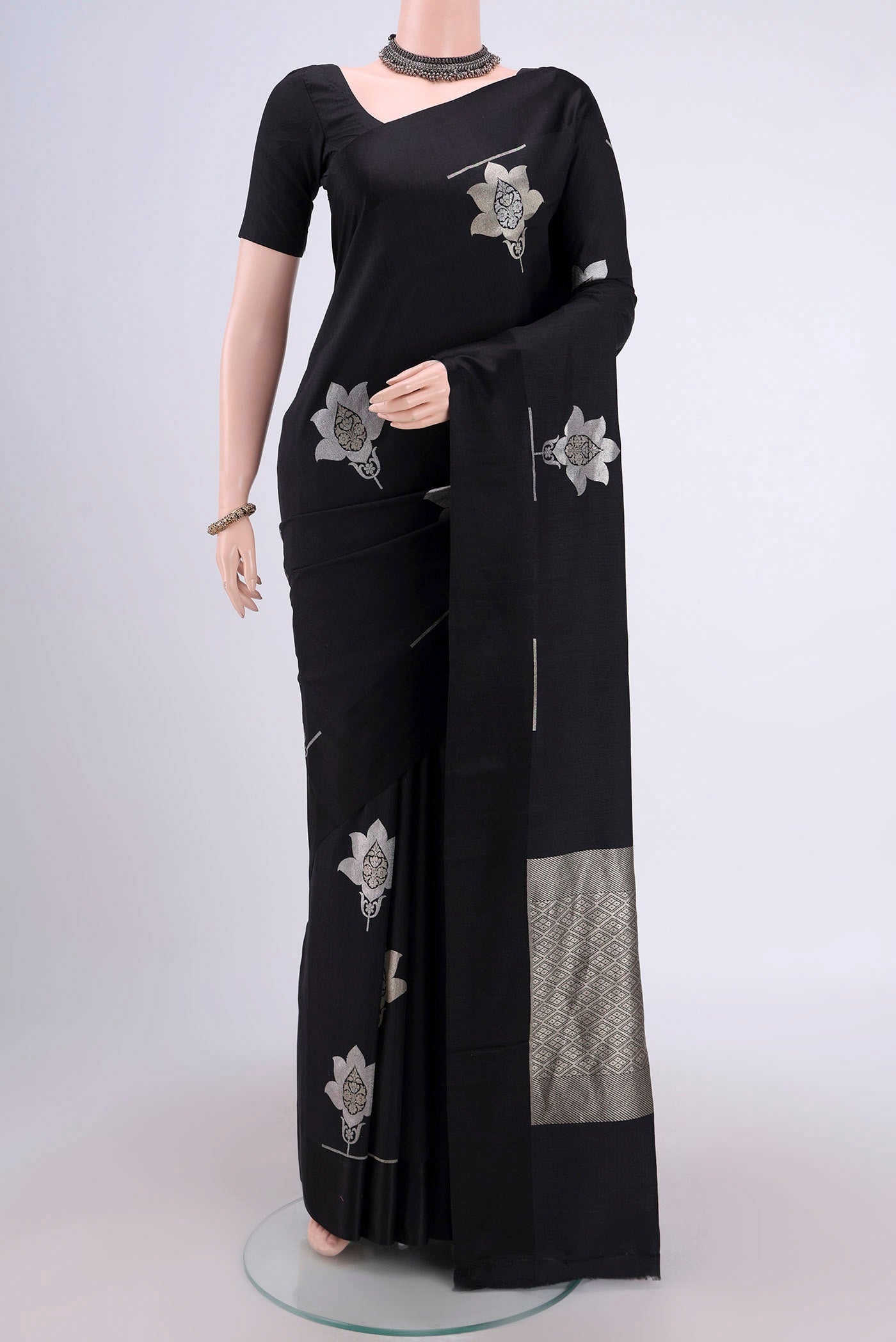 Black Banarasi Silk Saree with Zari Butta on the body and Zari Border.  displayed on a mannequin
