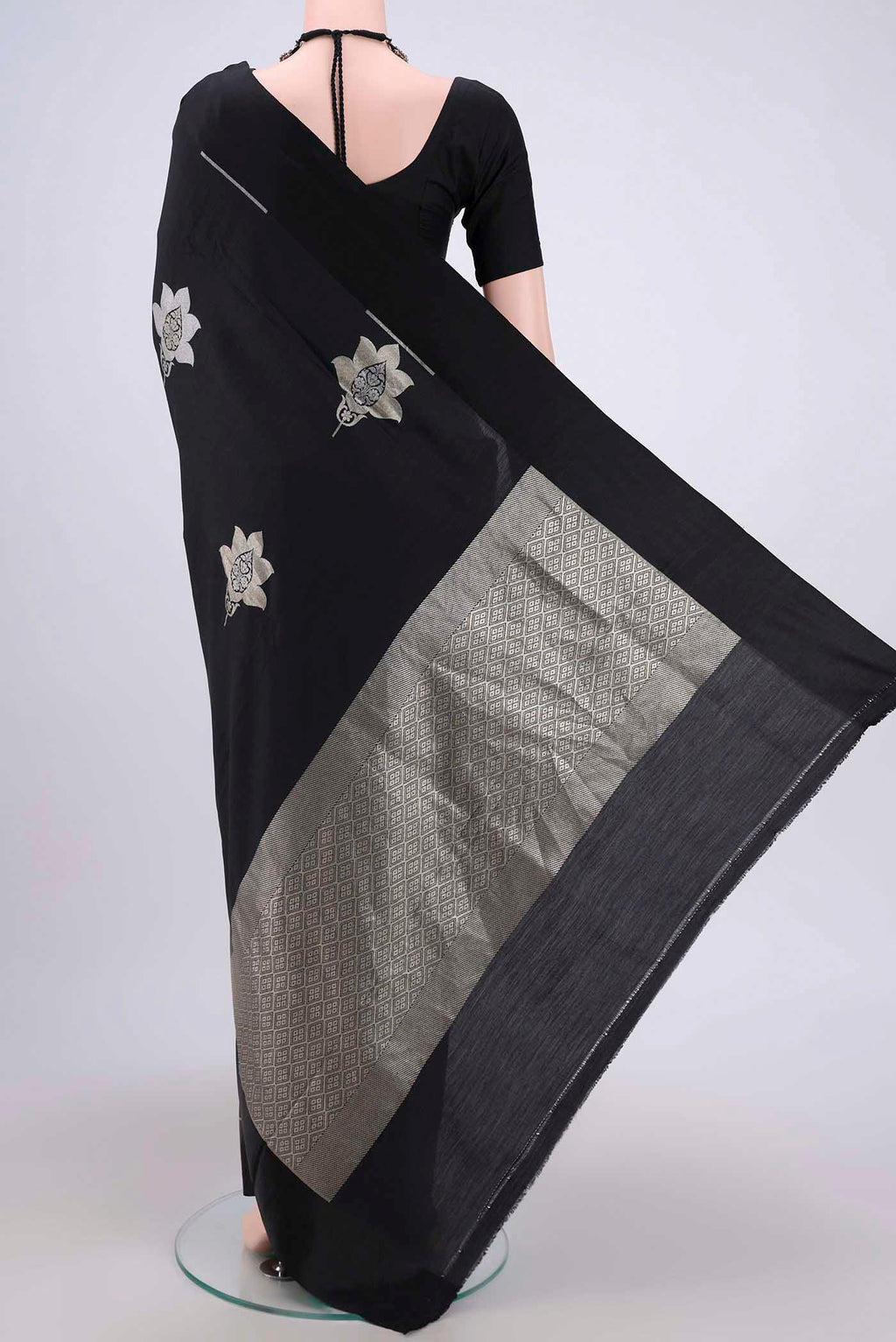 Flat view of Black Banarasi Silk Saree with Zari Butta on the body and Zari Border. 