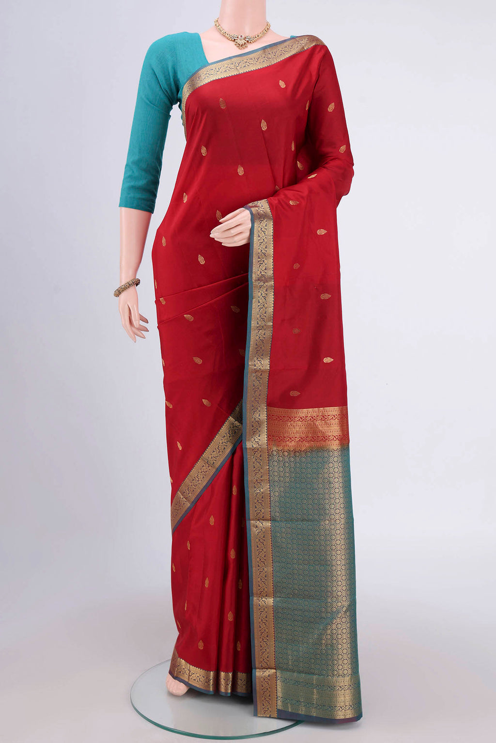 Maroon Dual Tone Nangavalli Silk [ Salem ] Saree with Zari Butta on the body and Zari Border.  displayed on a mannequin