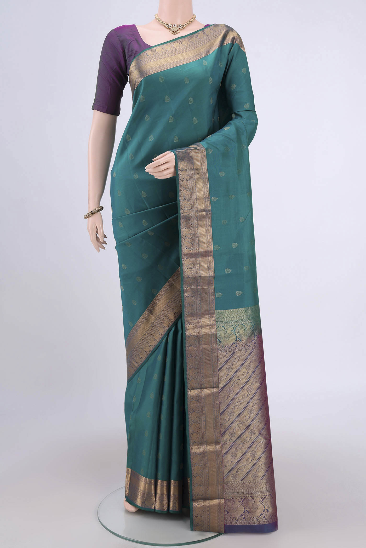 Orange with Pink Dual Tone Kanchipuram Silk Saree with Zari Butta on the body and Zari Border.  displayed on a mannequin
