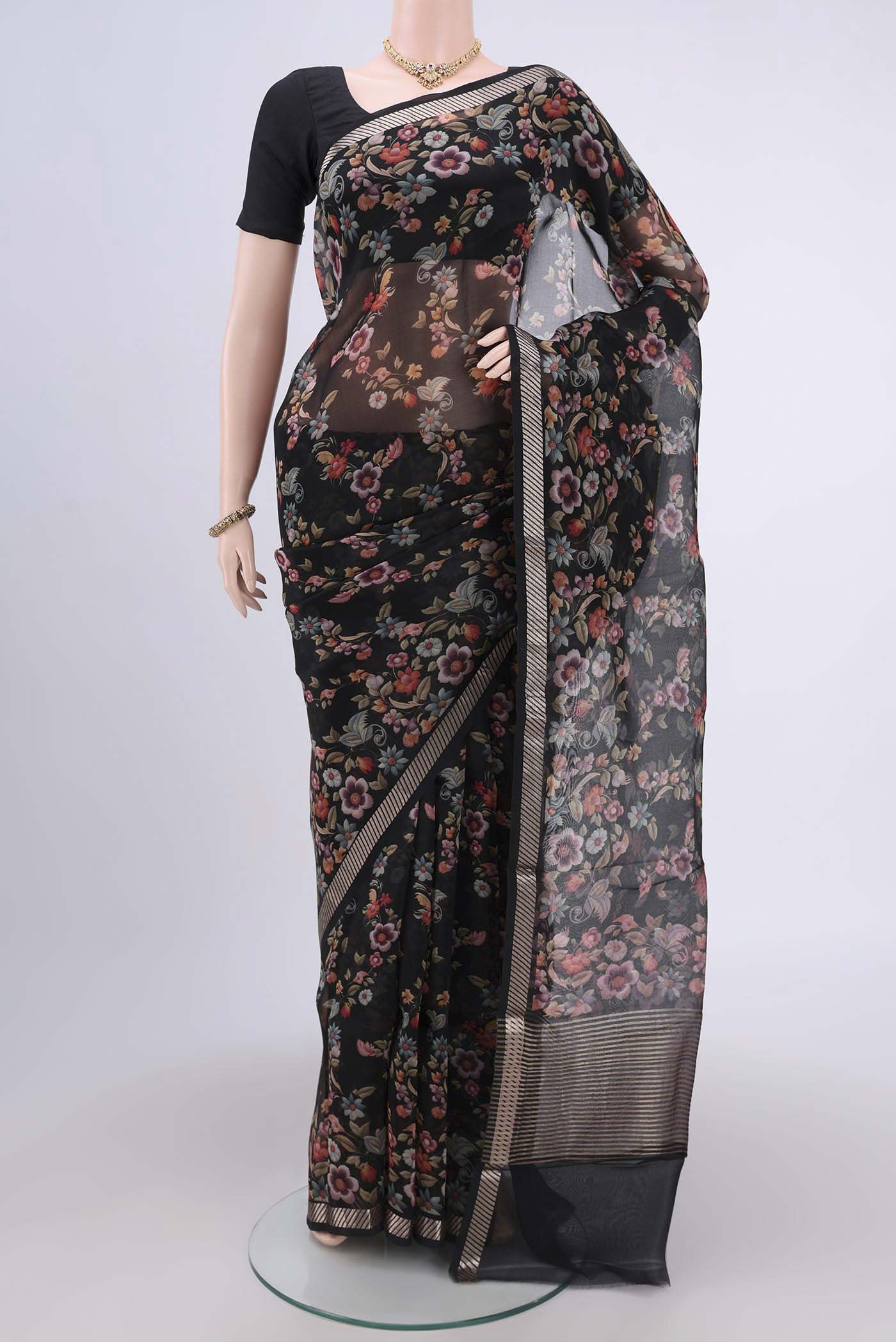 Light Green Organza Silk Saree with Floral Print on the body and Zari Border.  displayed on a mannequin