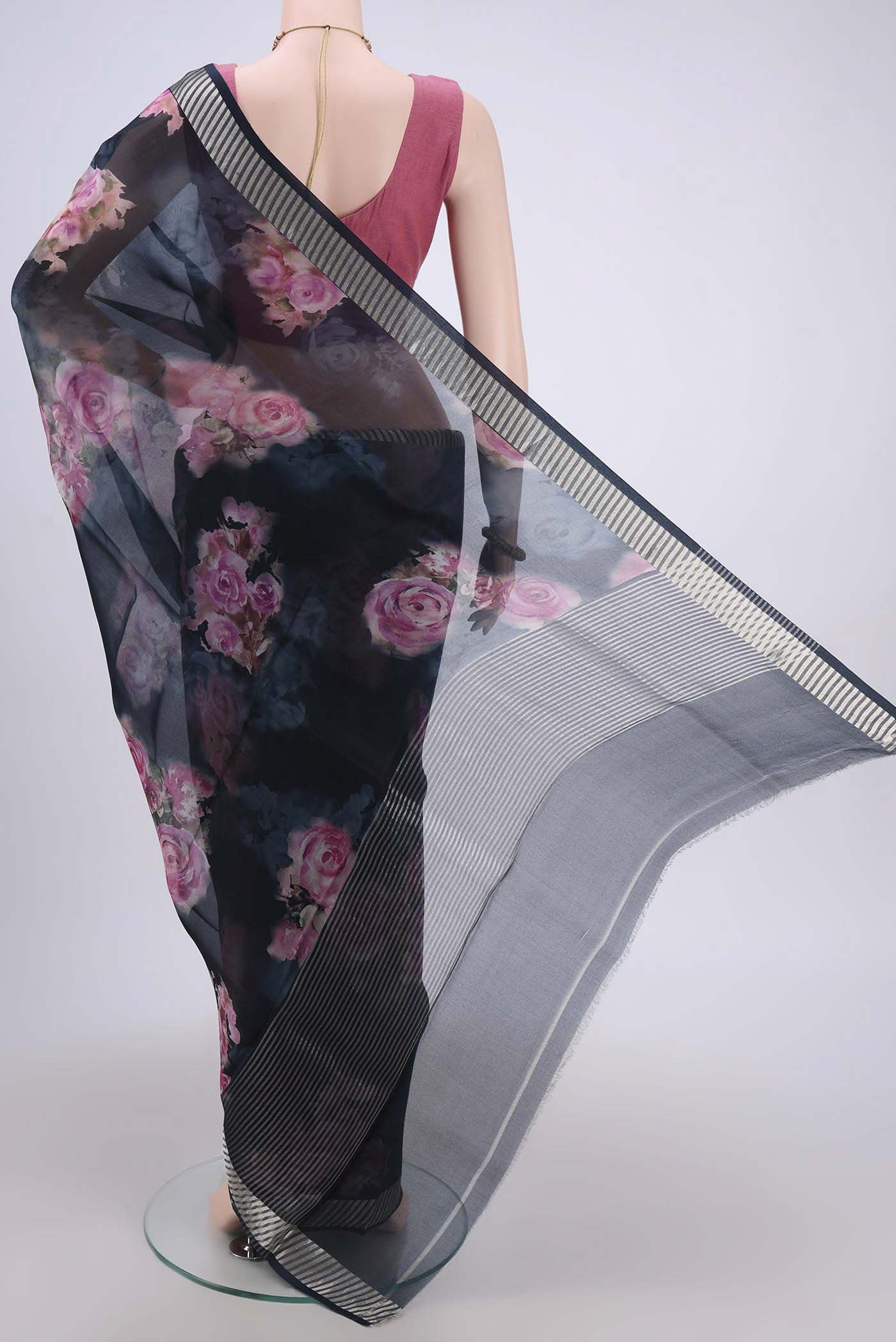 Flat view of Navy Blue Organza Silk Saree with Floral Print on the body and Zari Border. 