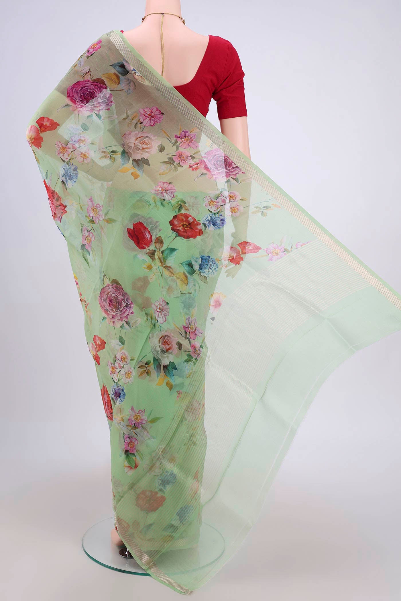 Flat view of Light Green Organza Silk Saree with Floral Print on the body and Zari Border. 