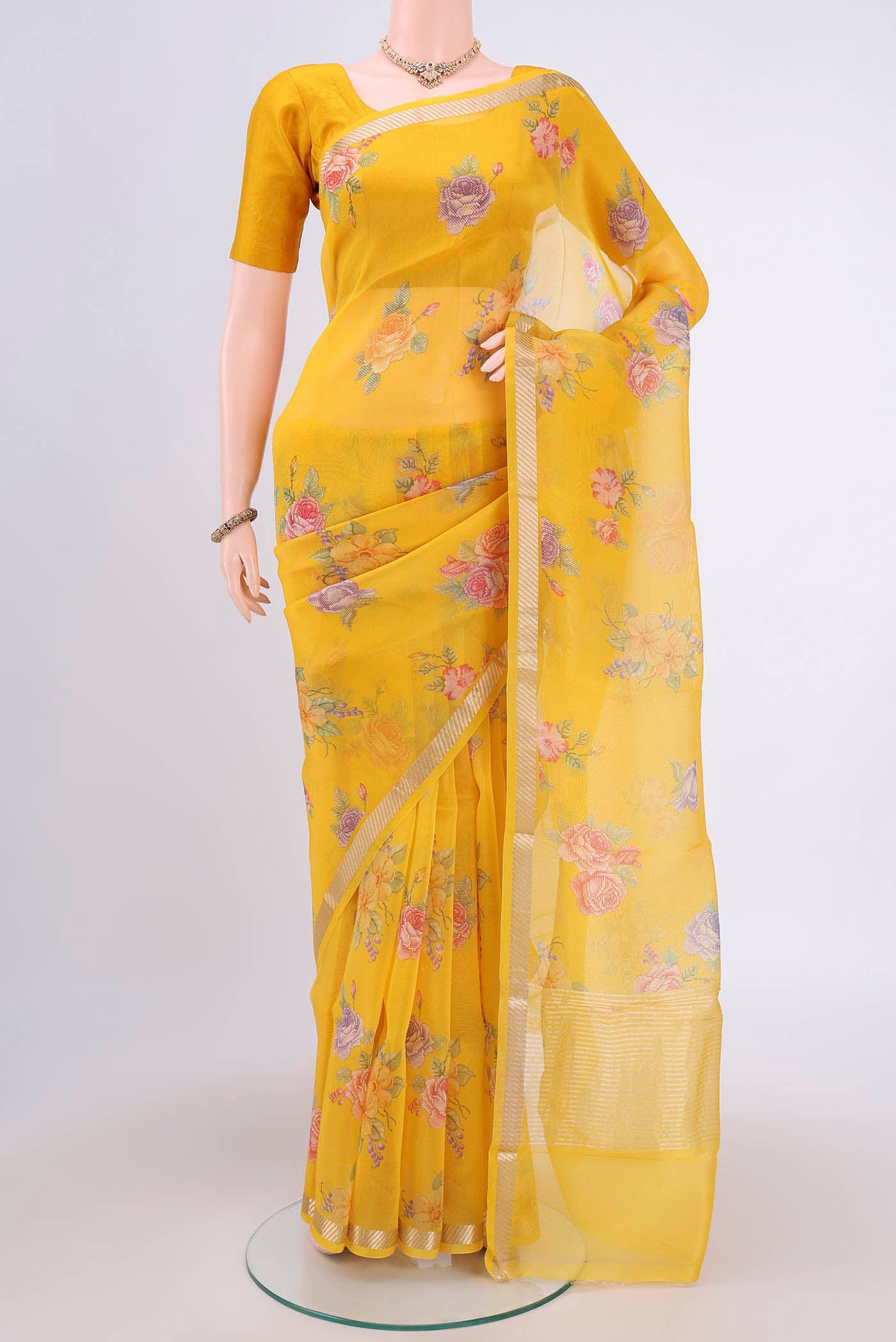 Yellow Organza Silk Saree with Lehariya on the body and Zari Border.  displayed on a mannequin
