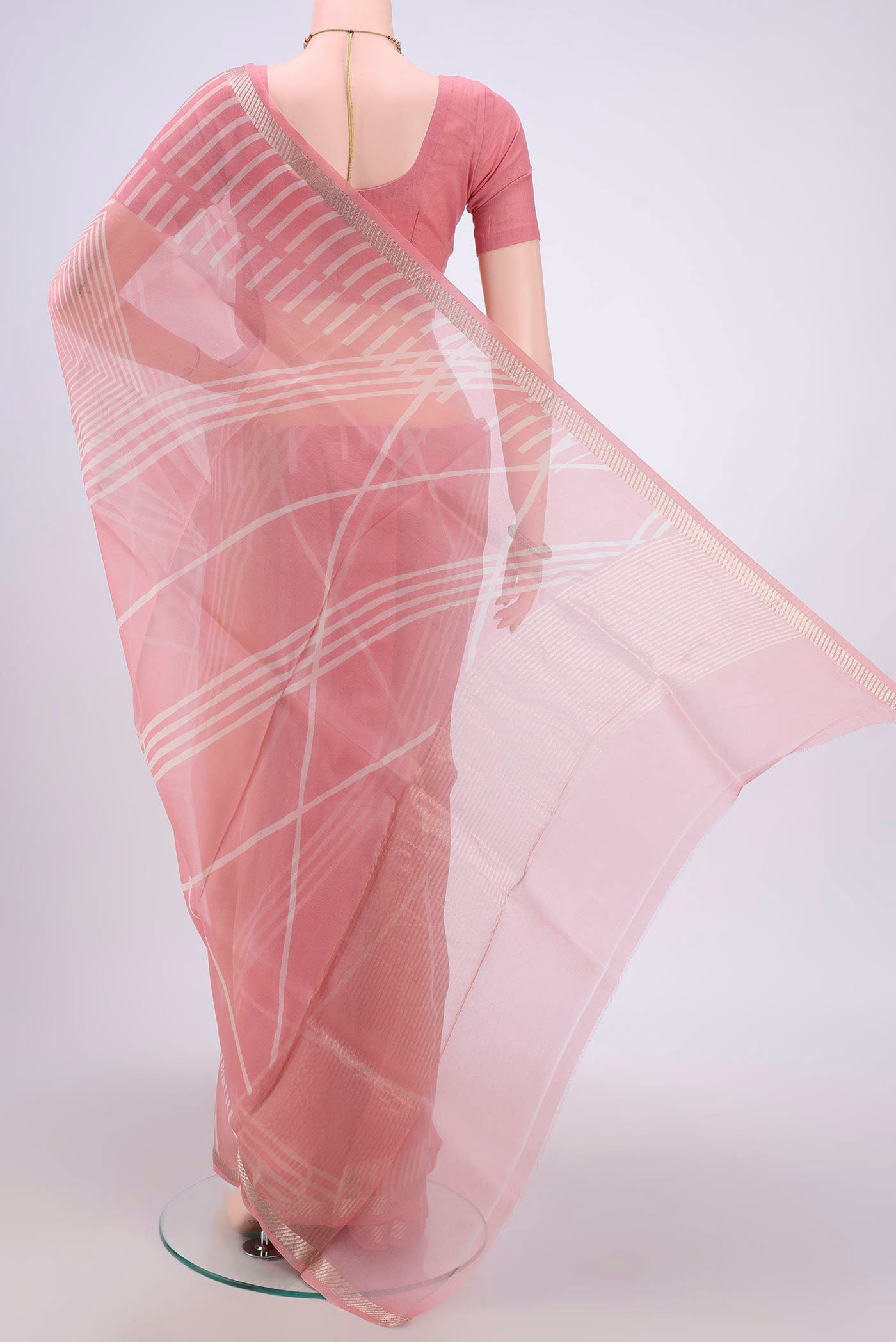 Flat view of Peach Organza Silk Saree with Floral Print on the body and Zari Border. 