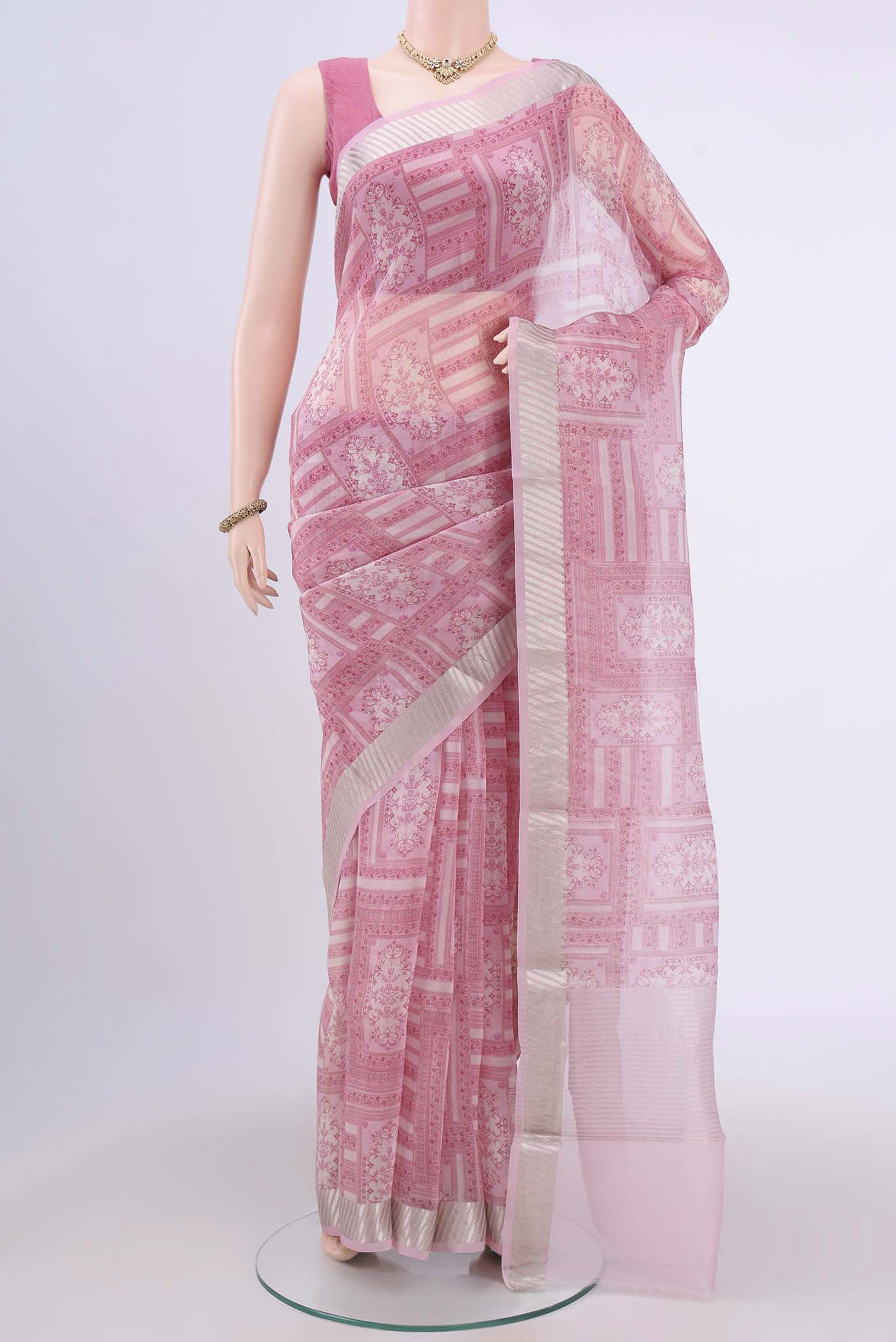 Rose pink Organza Silk Saree with Printed design on the body and Zari Border.  displayed on a mannequin